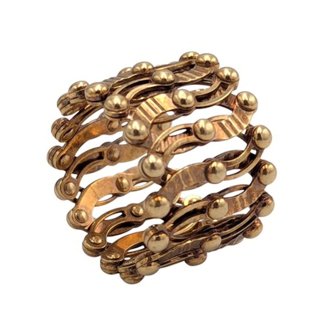 A metamorphic 9ct gold expanding trellis ring bracelet, from...