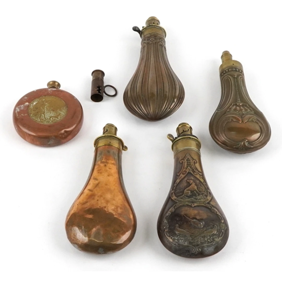 Five 19th century and later brass and copper powder flasks c...