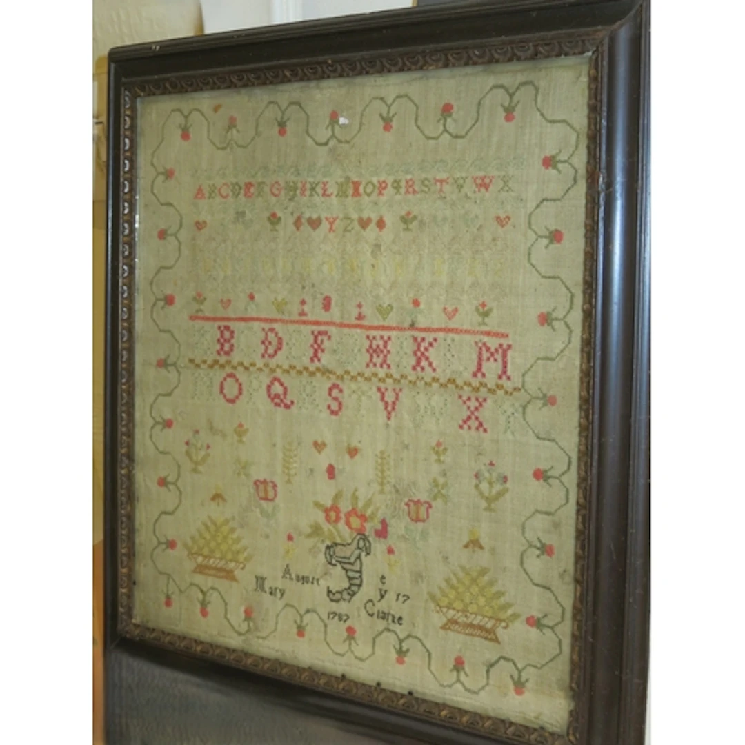 George III needlework sampler, of alphabet and floral design...