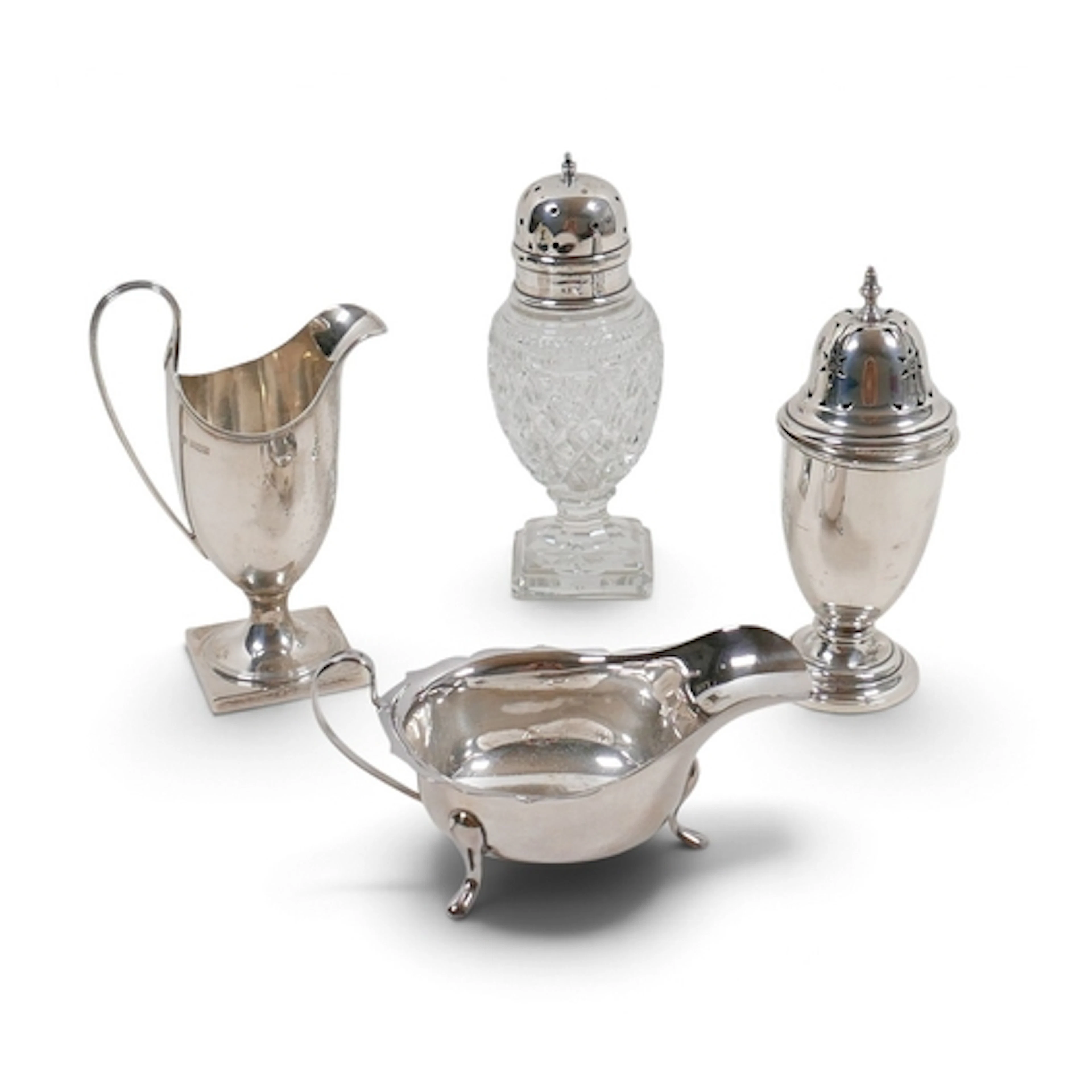 A GROUP OF FOUR SILVER ITEMS. comprising helmet shaped cream...