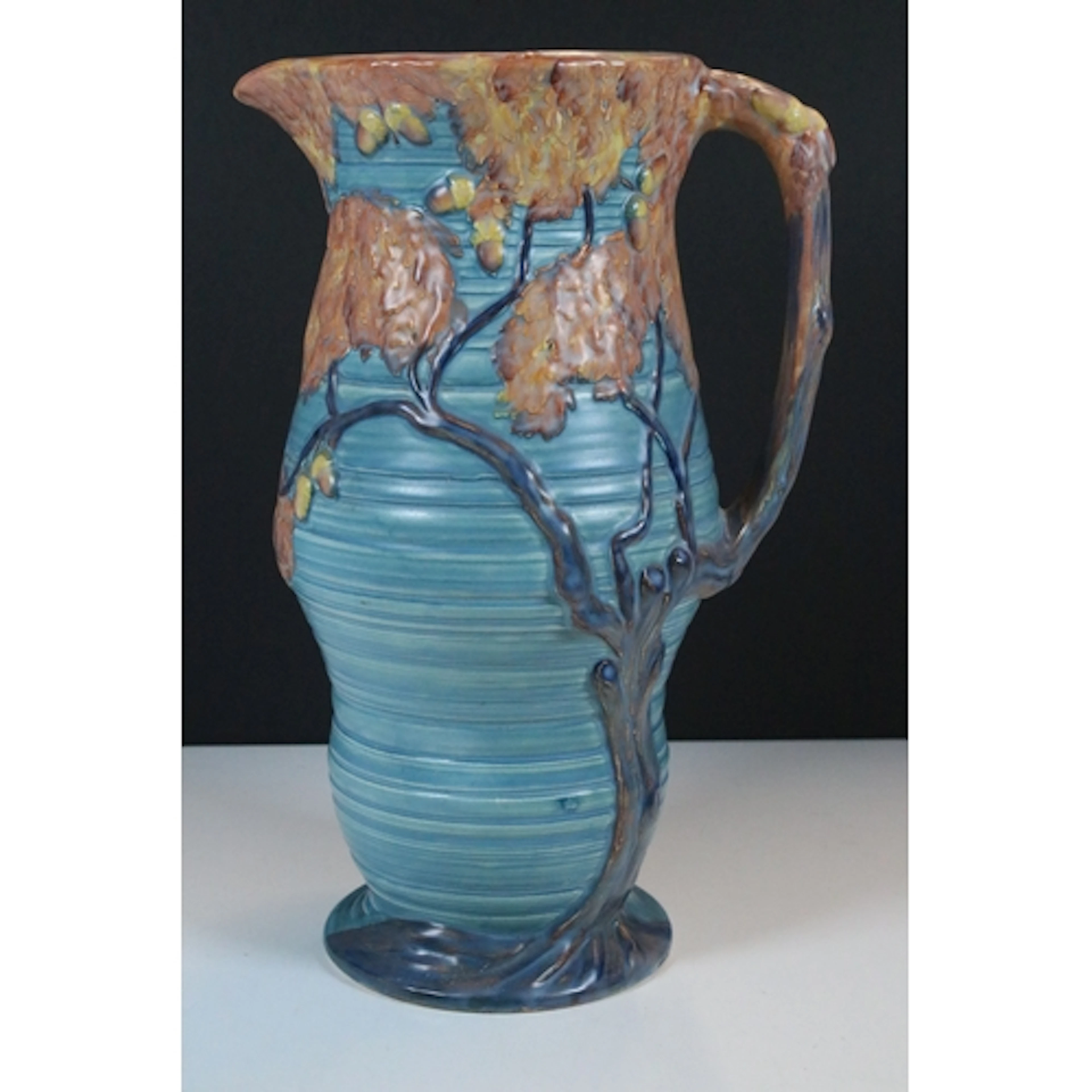 Carltonware art deco jug, having painted relief work of an o...