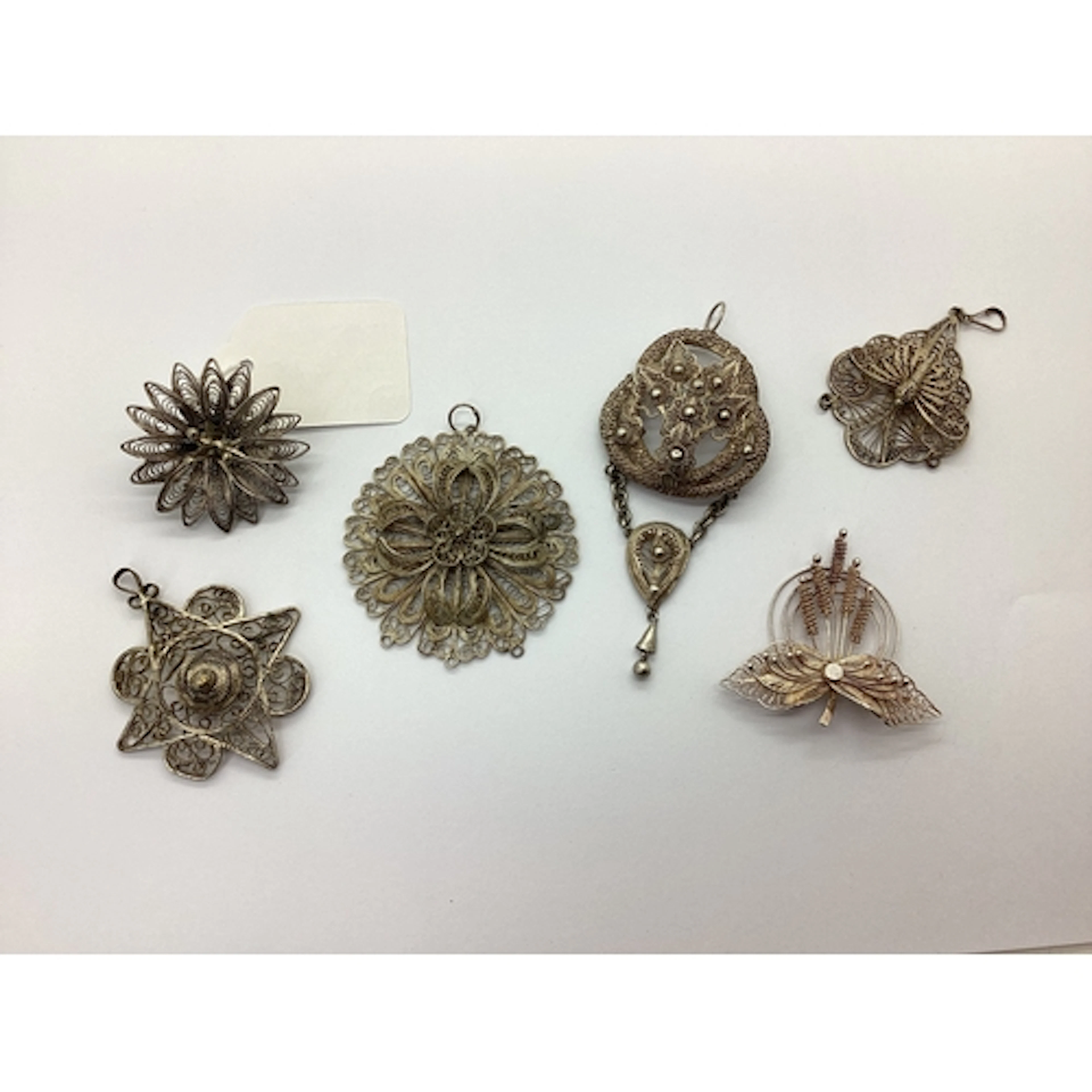 A Selection of Decorative Filigree Pendants and Brooches, in...