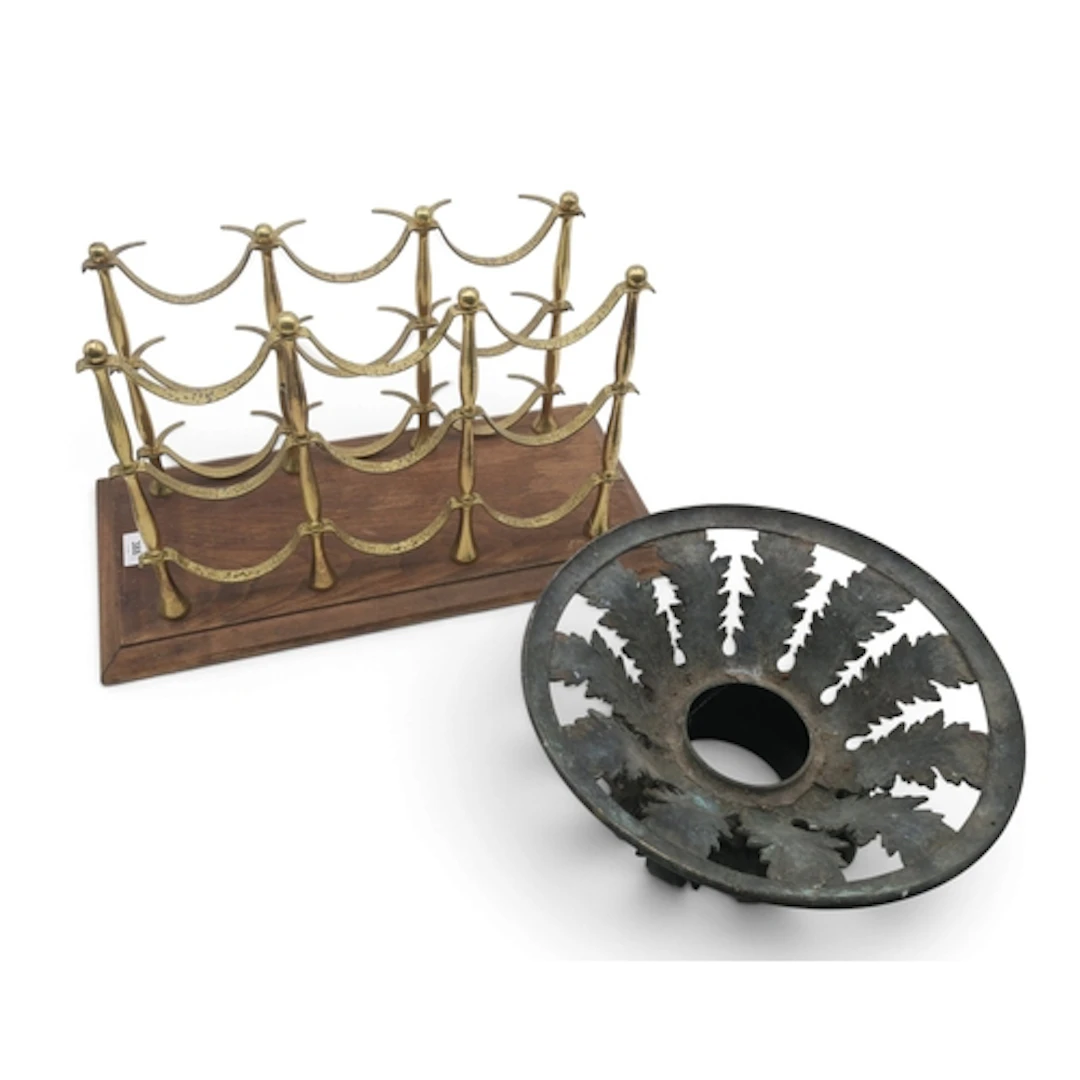 A brass wine rack on rectangular wooden base and a cast iron...