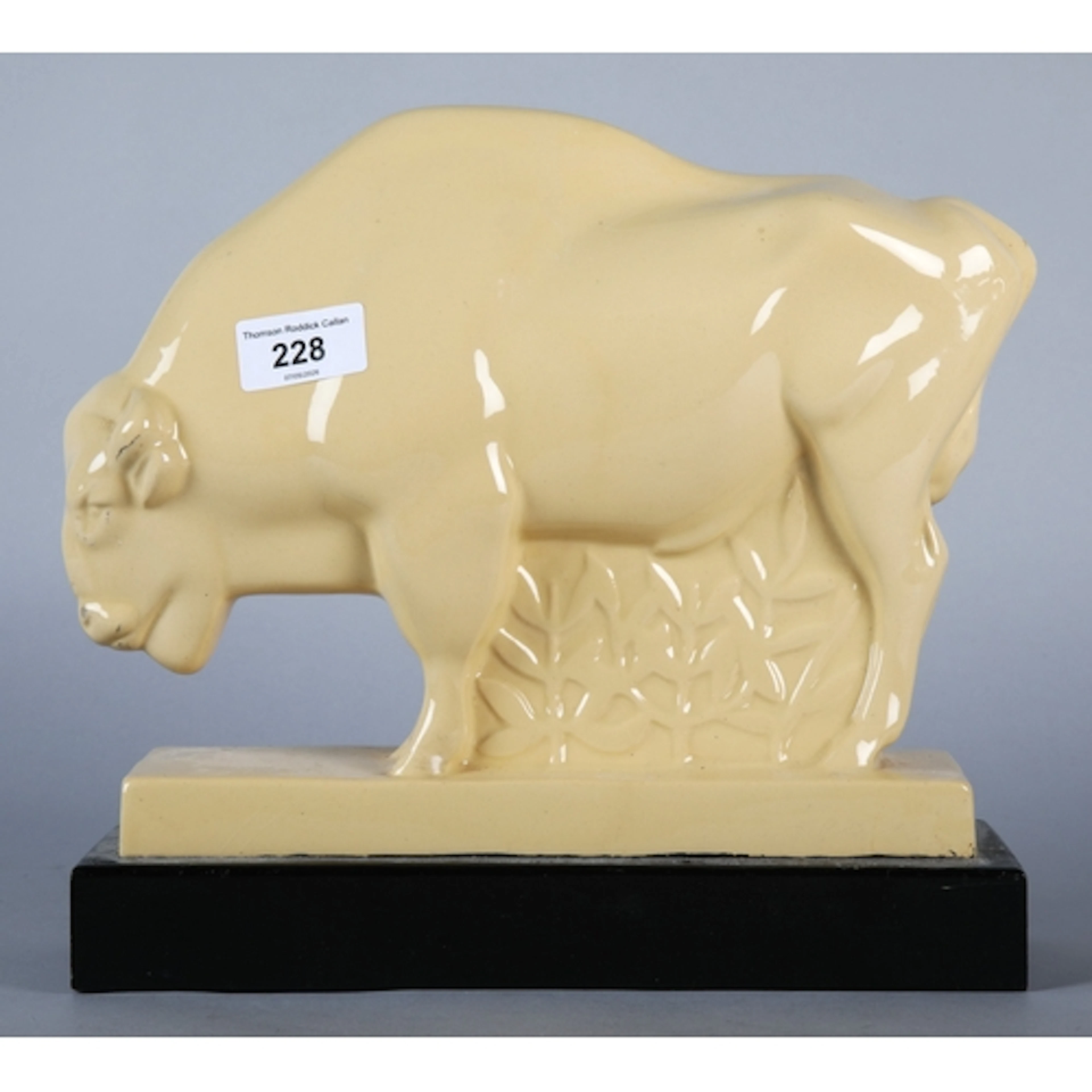 Wedgwood bison figure by John Skeaping mounted on a black wo...