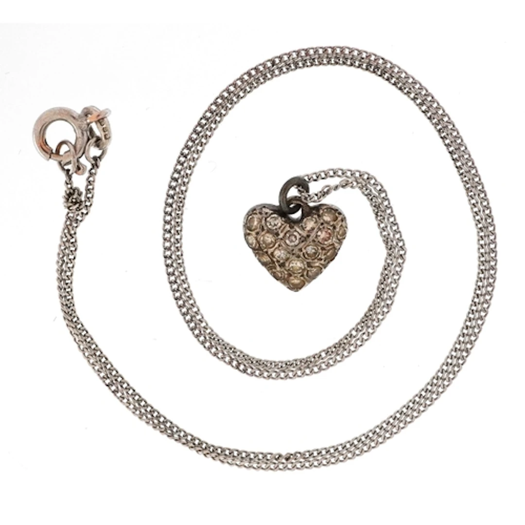 White metal diamond love heart pendant on a 9ct white gold n...
