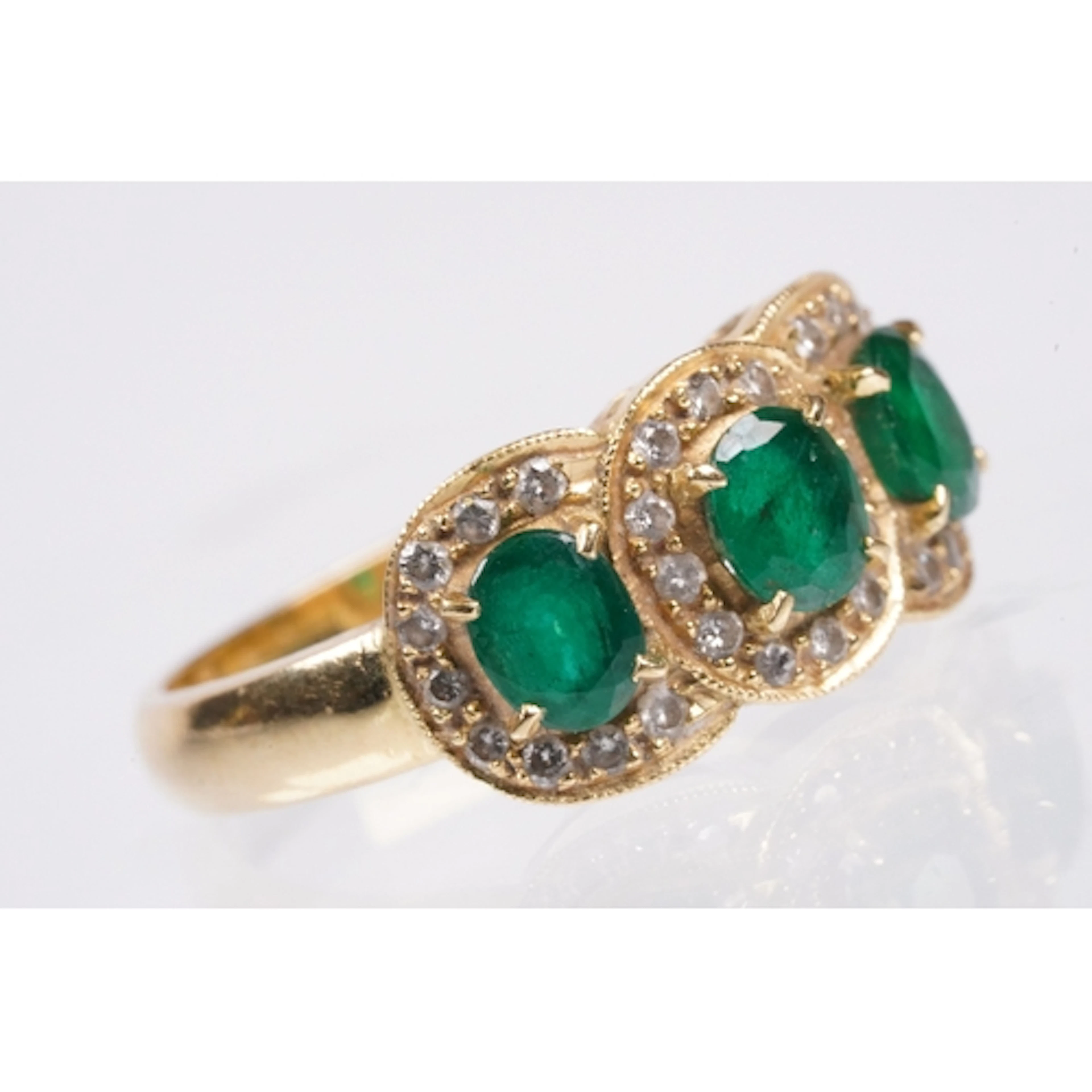 18ct gold, emerald and diamond ring. The ring being set with...