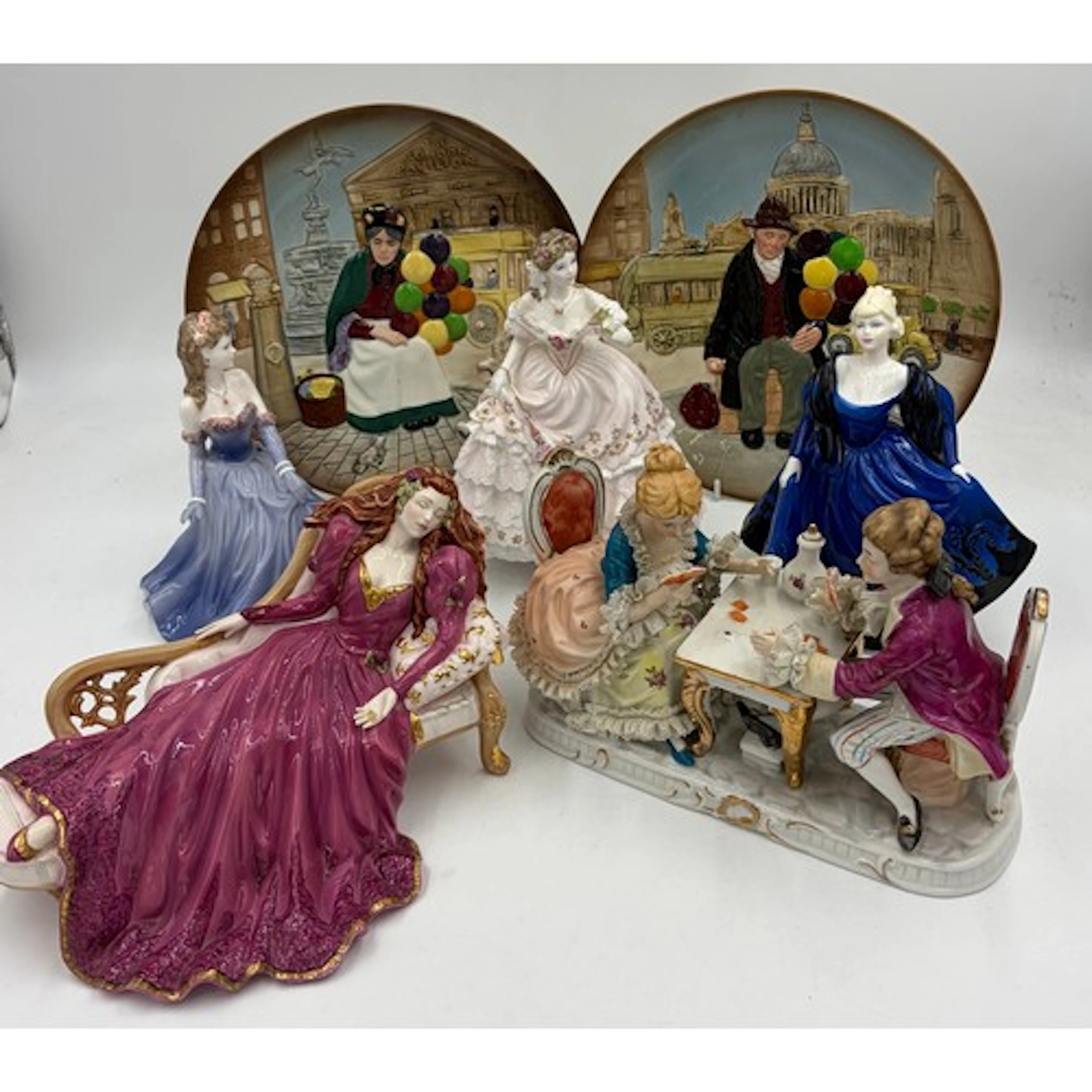A Dresden style figurine depicting Victorian couple playing ...