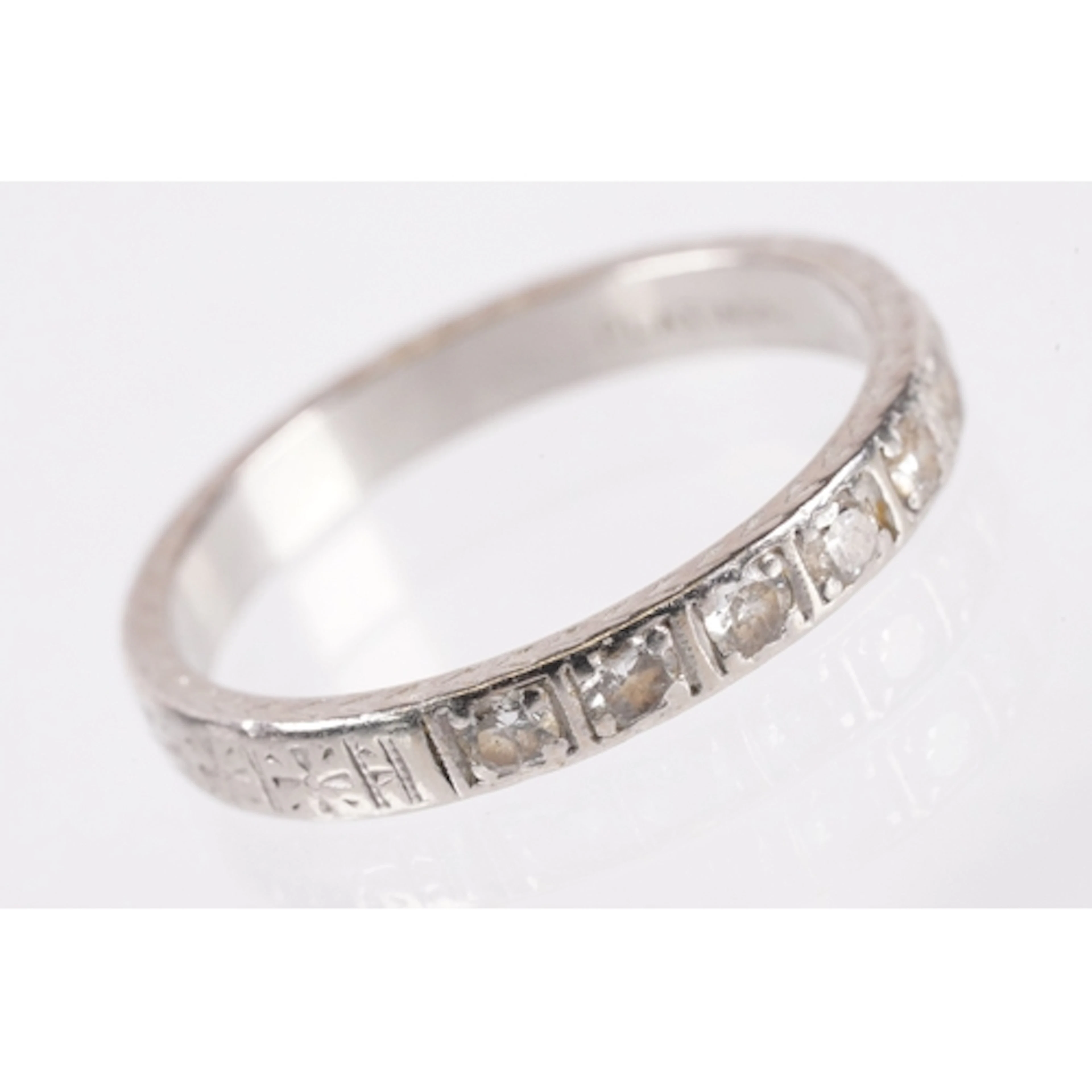 Platinum and diamond band ring. The ring being engraved thro...