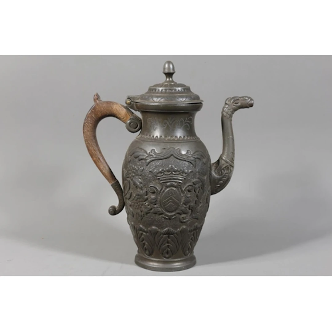 Antique pewter coffee pot decorated with armorial crests, dr...