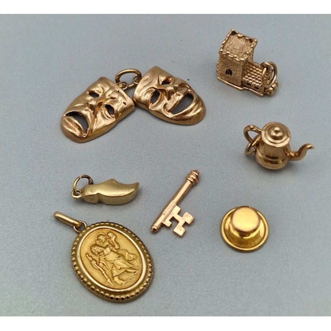 Collection of 9ct gold charms to include: key, Dutch clog, t...