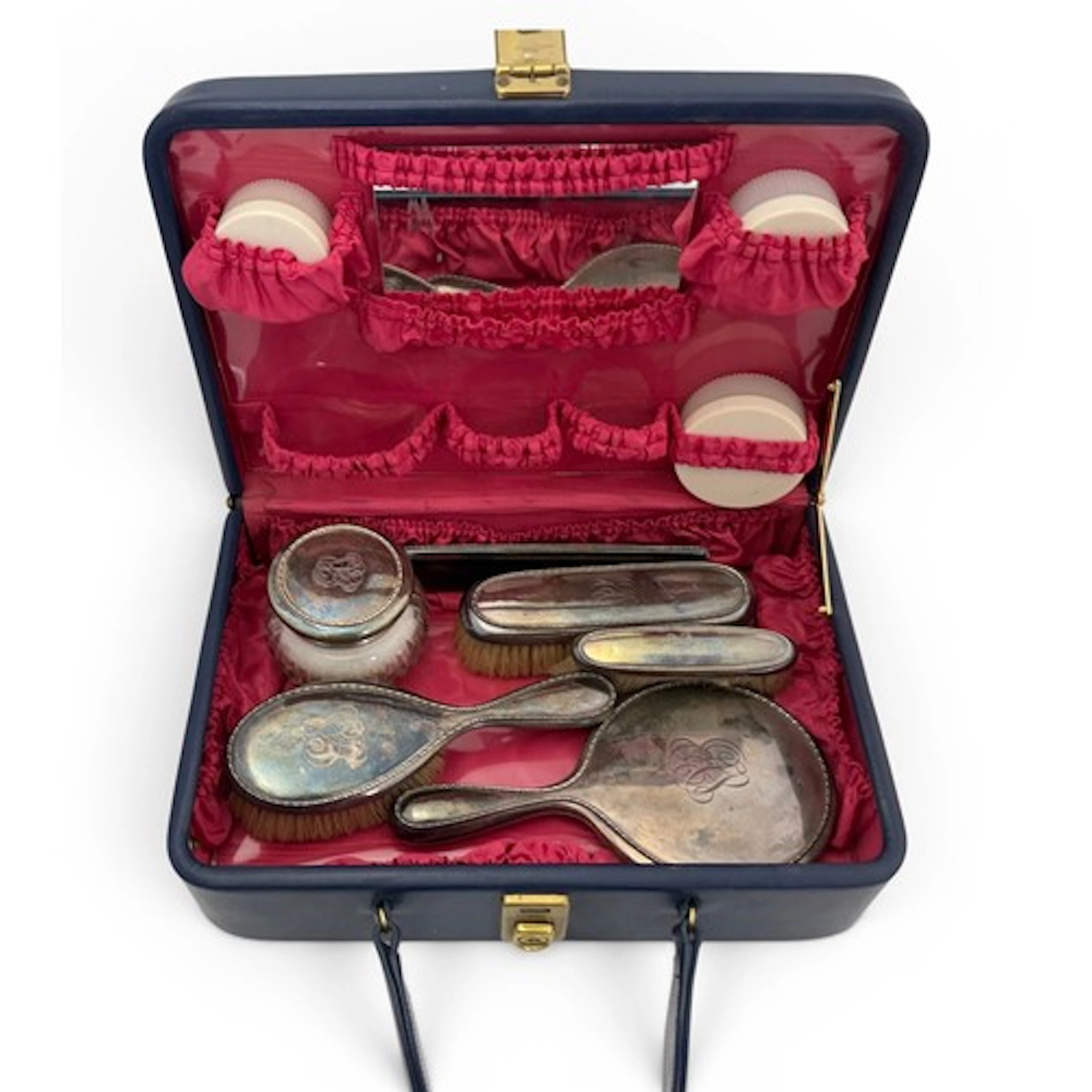 A blue leather travelling vanity case containing a Birks Ste...