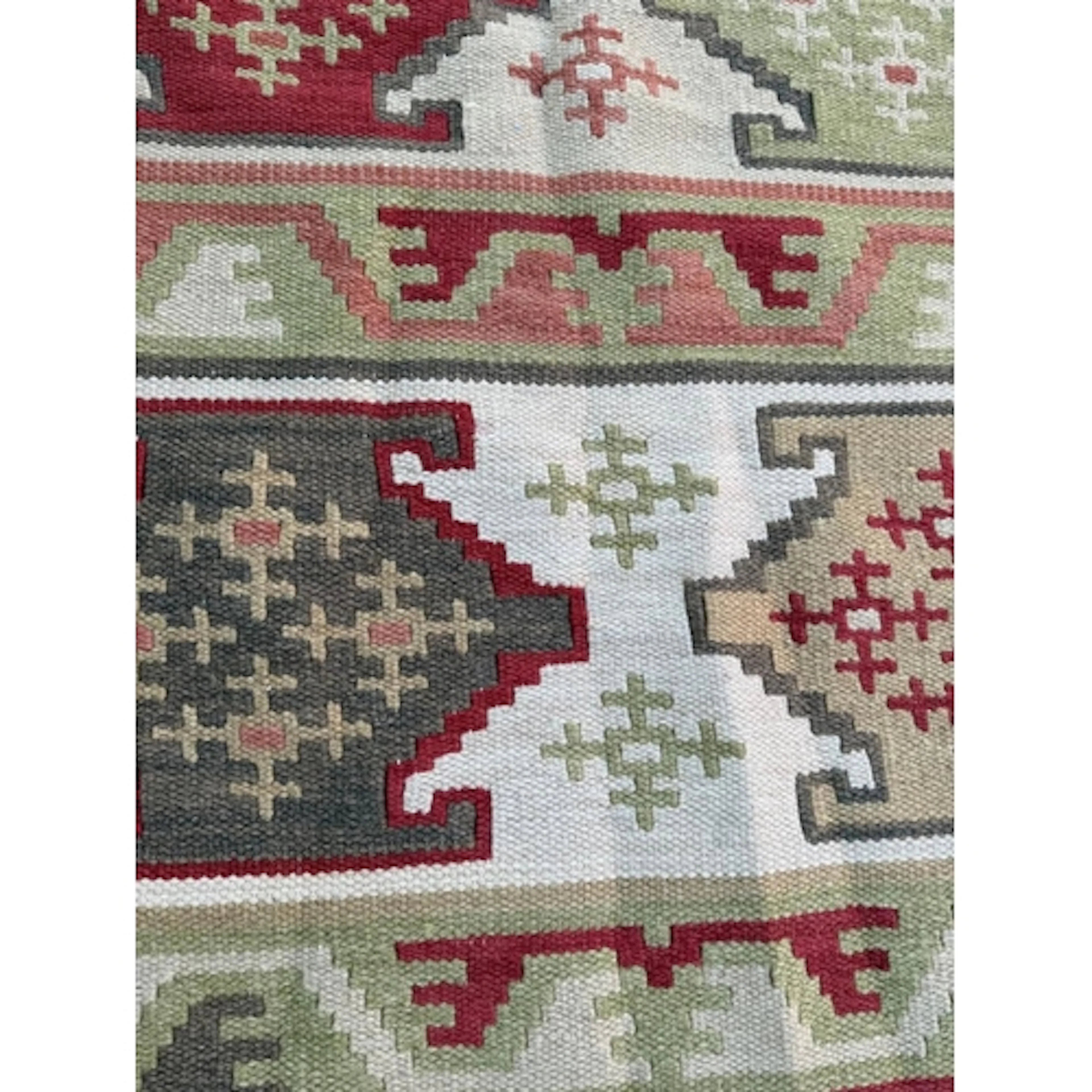 An Aztec style woven rug with geometric border