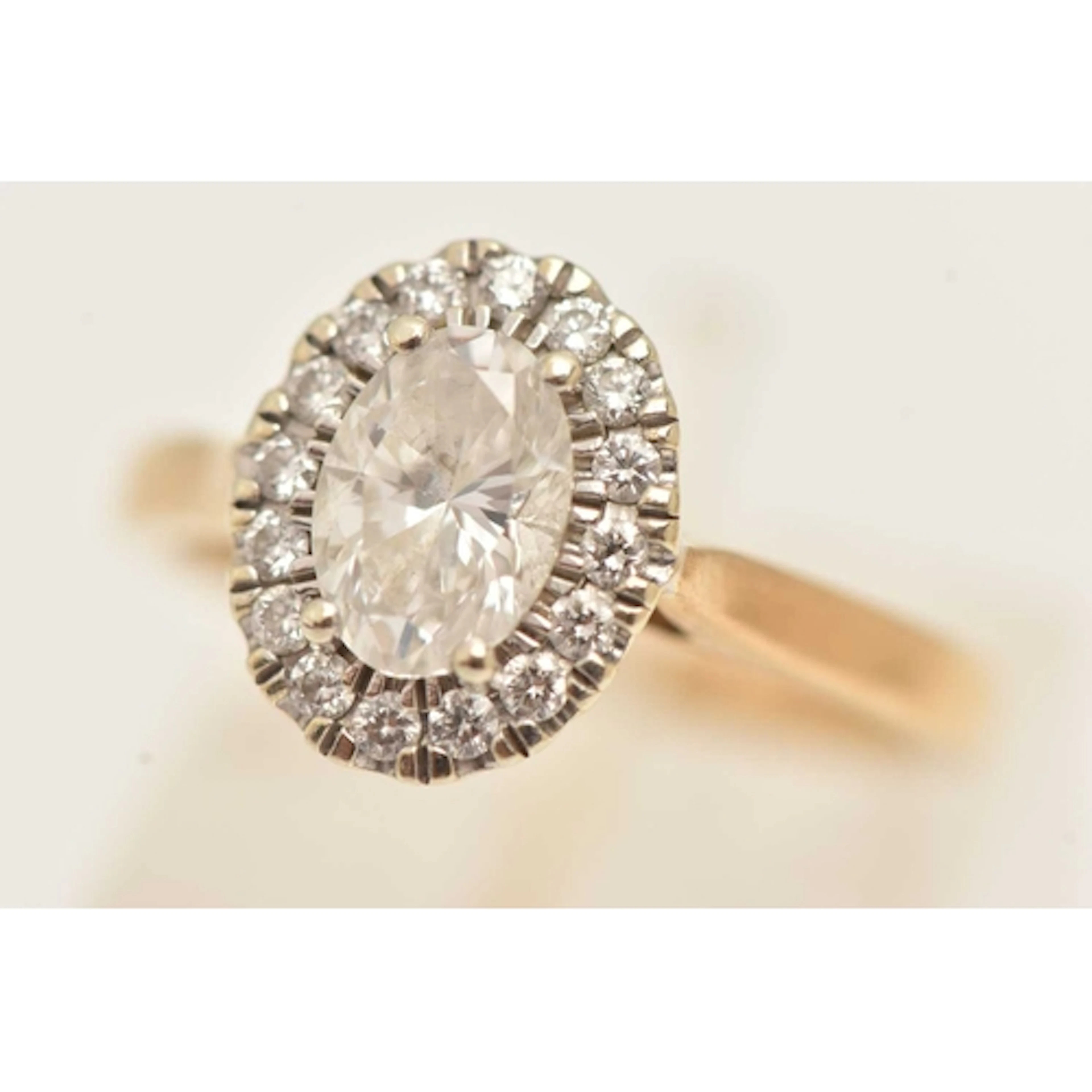 A 9CT GOLD LAB GROWN DIAMOND HALO RING, of an oval form, pin...