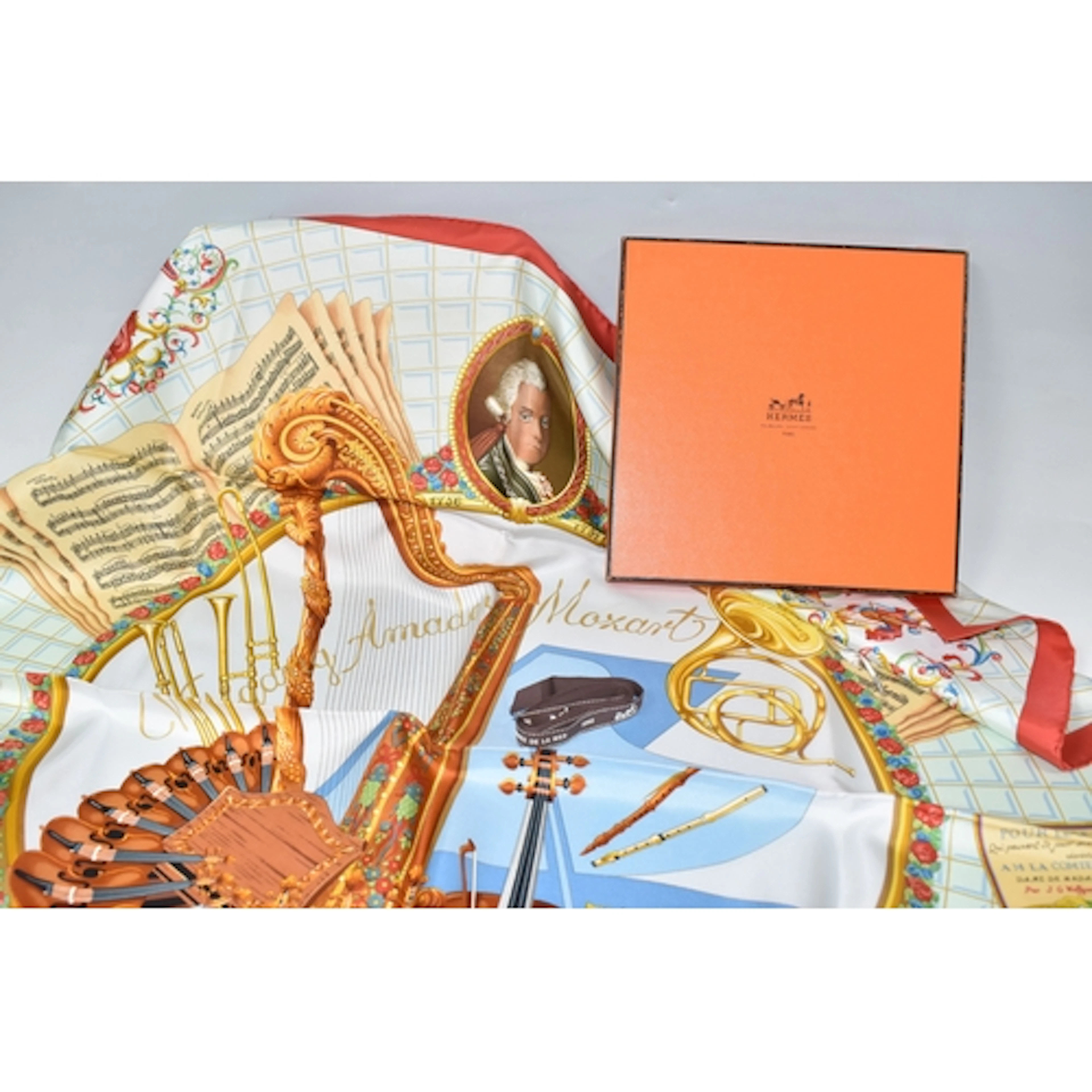 A BOXED HERMES 'AMADEUS MOZART' SILK SCARF with a brown 'Her...