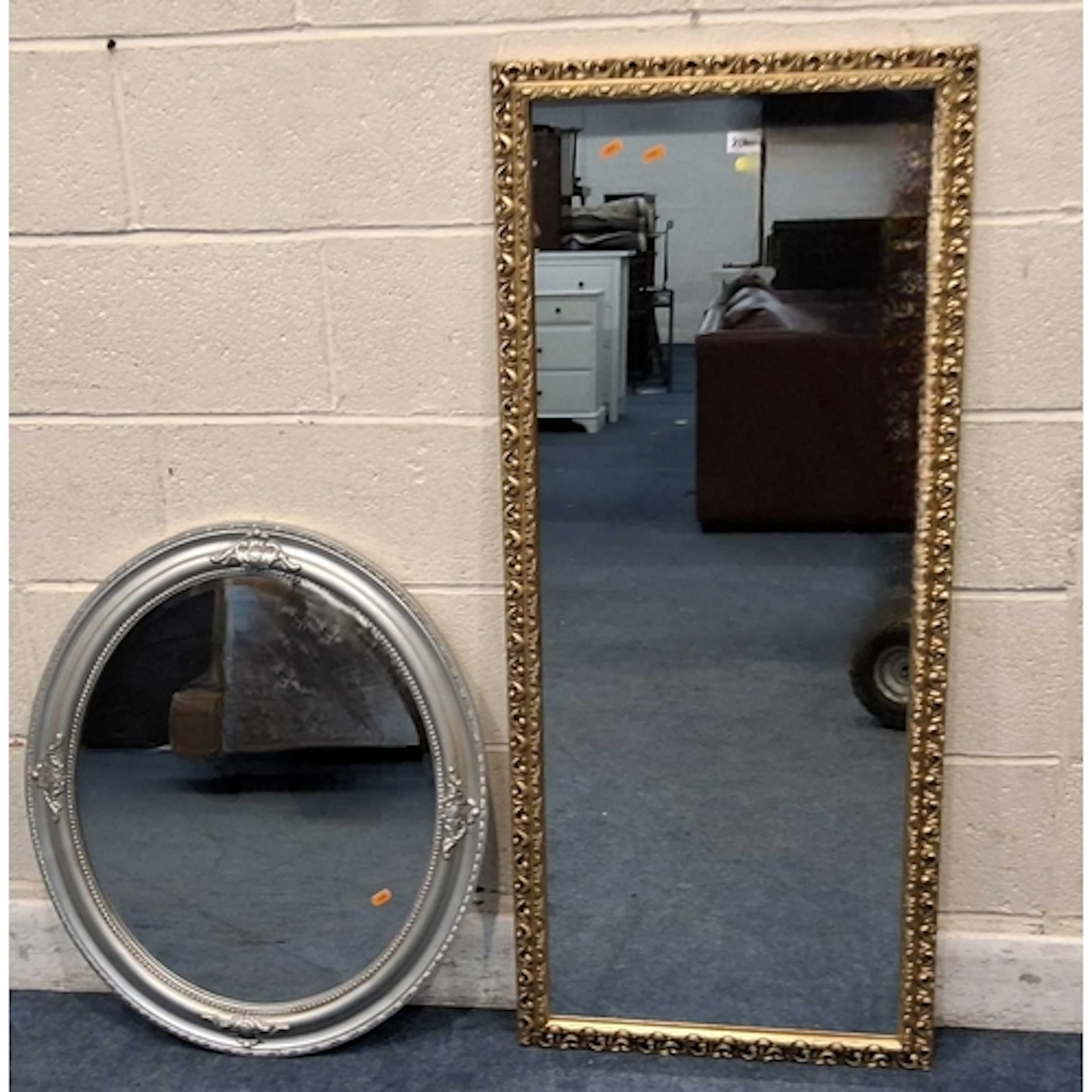 A GILT WOOD RECTANGULAR WALL MIRROR, along with an oval mirr...