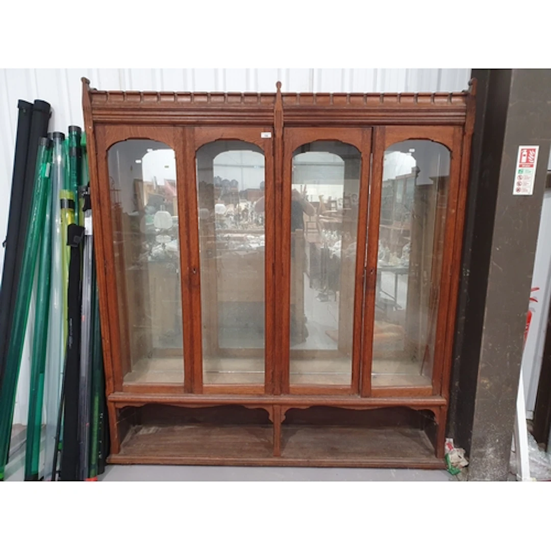 A late 19th Century oak glazed Bookcase with four arched gla...