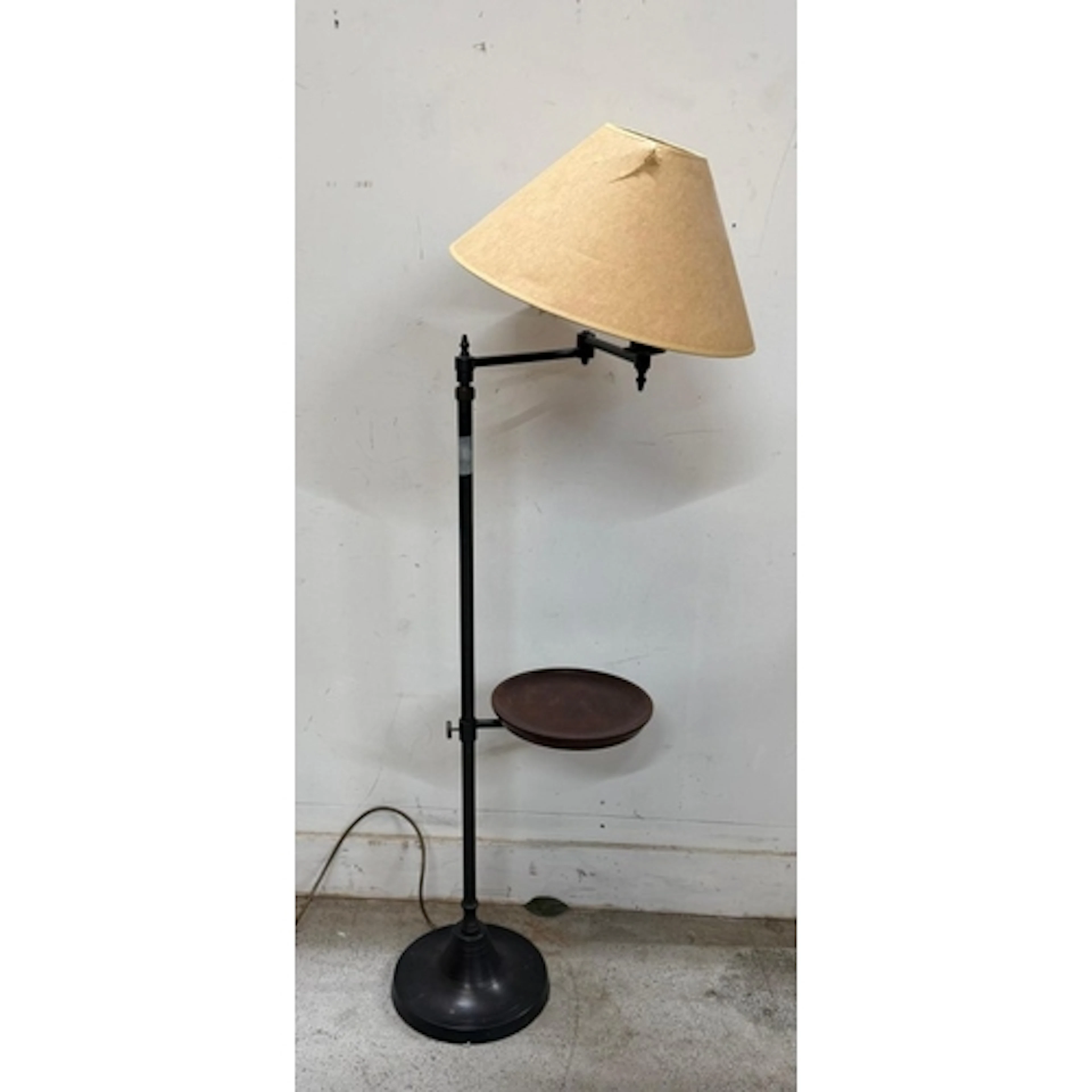 A floor lamp with integrated wooden circular shelf.