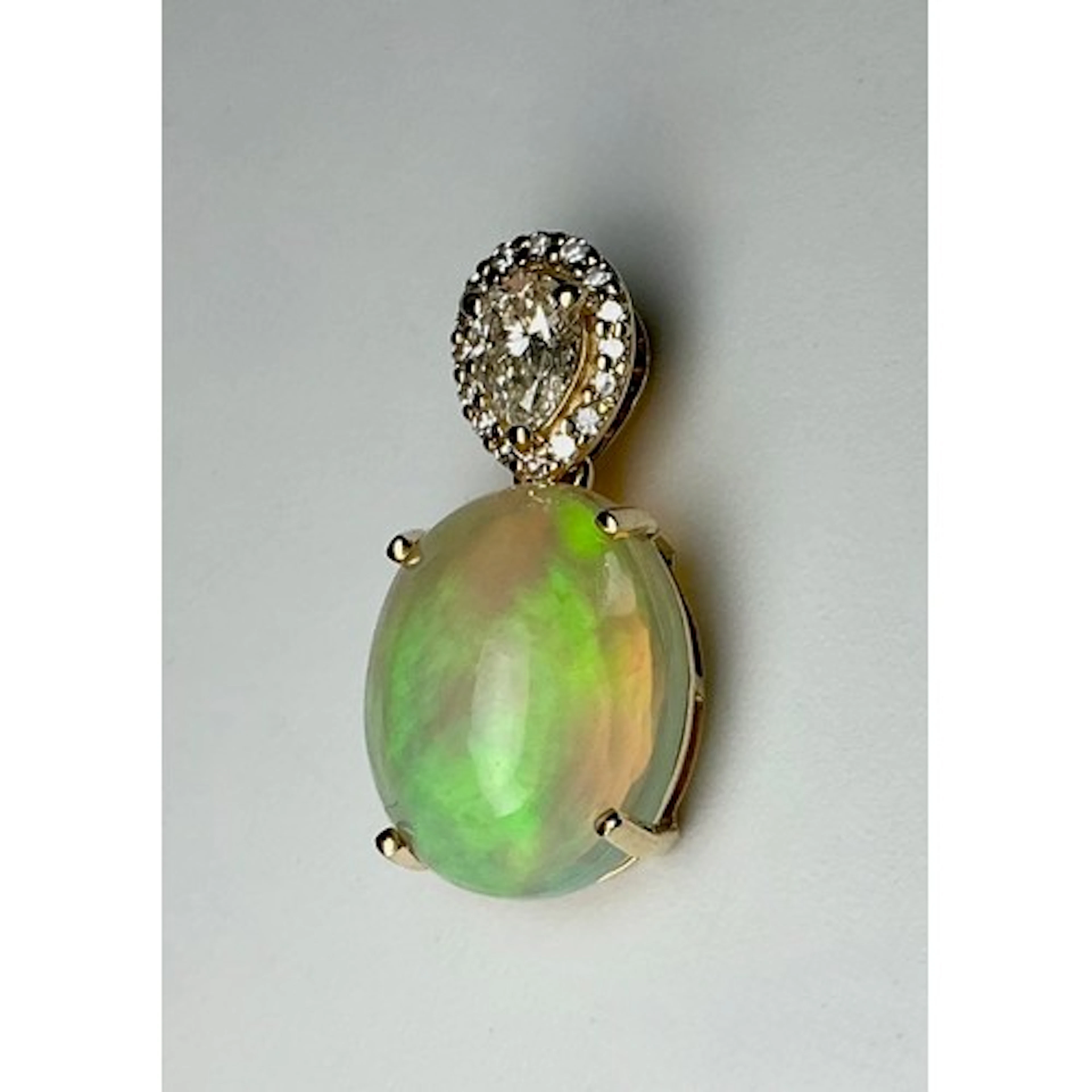 A diamond and opal pendant, central creamy oval cabochon opa...