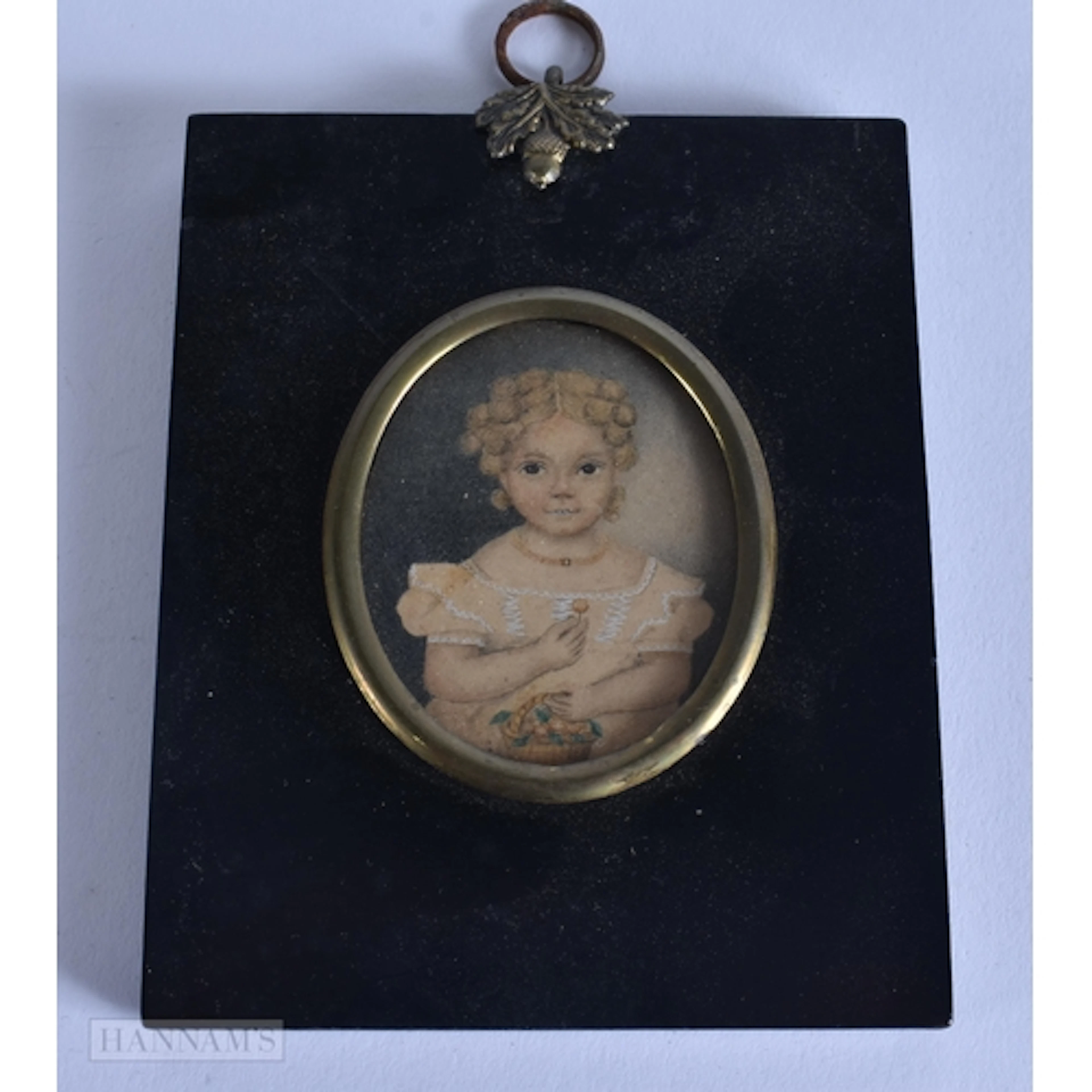 An early 19th Century portrait miniature of a young girl wit...