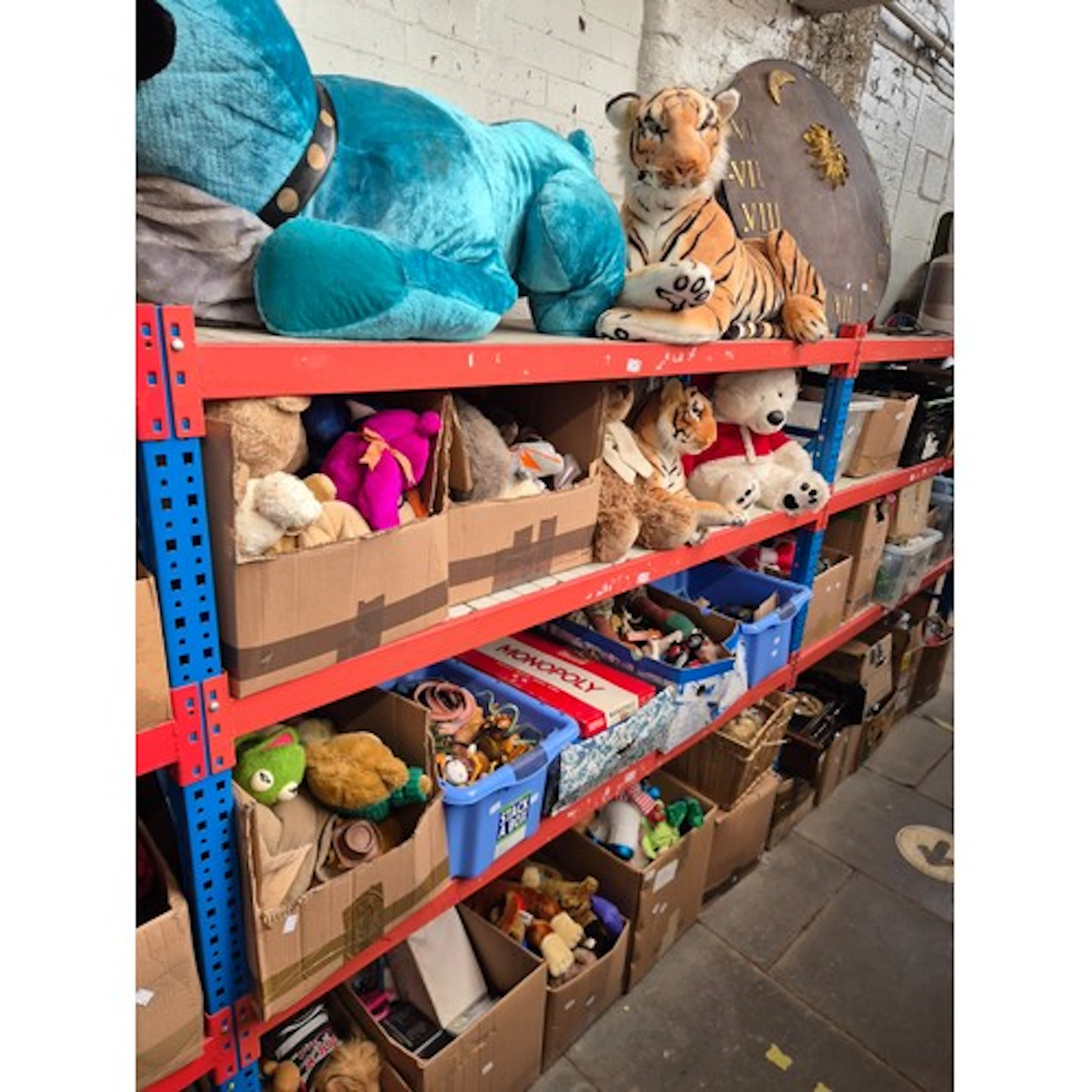 4 shelves of toys and games, mainly soft toys including very...