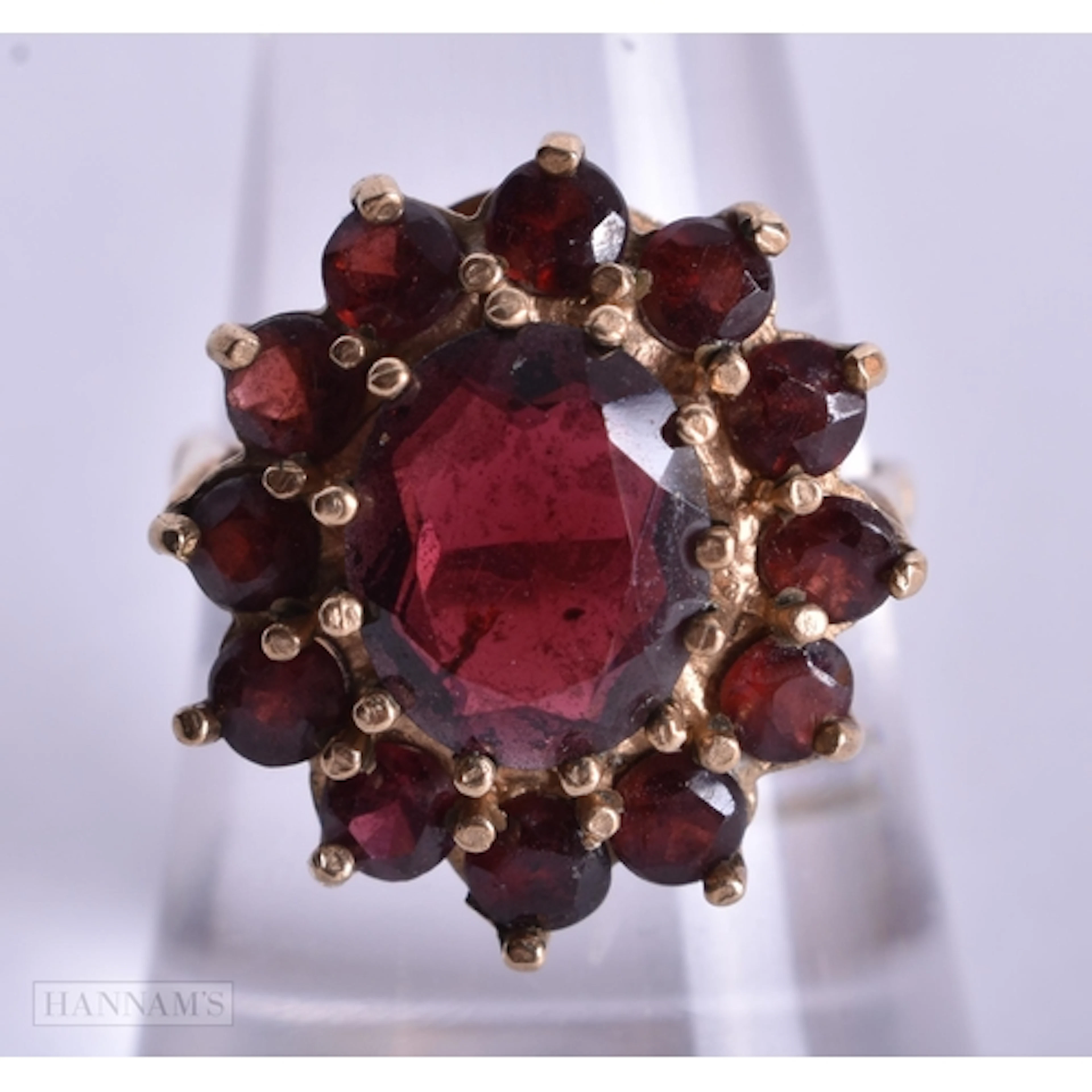 A 9CT GOLD GARNET COCKTAIL RING. 4.8 grams. O.