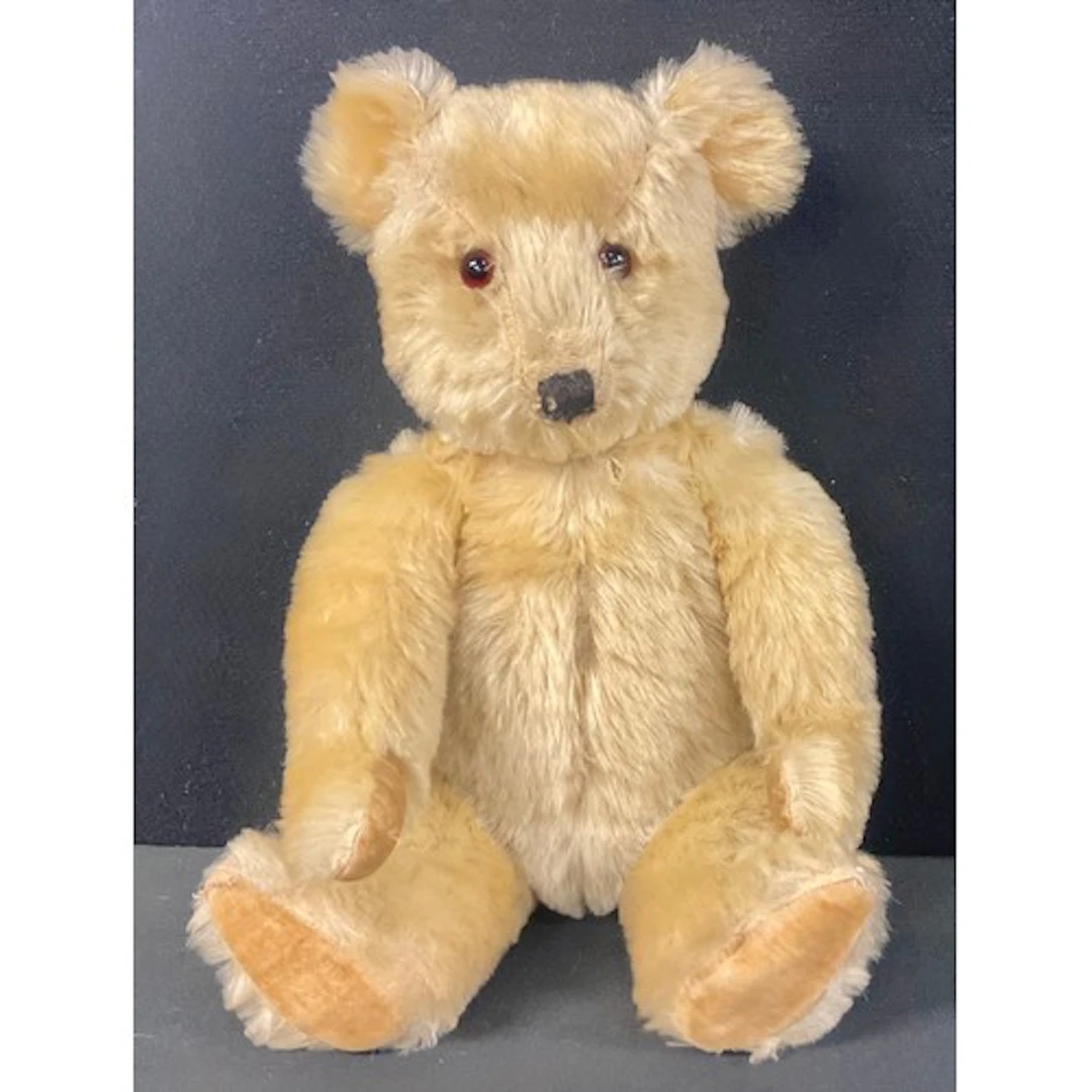 A mid 20th century gold plush teddy bear, centre seam, verti...