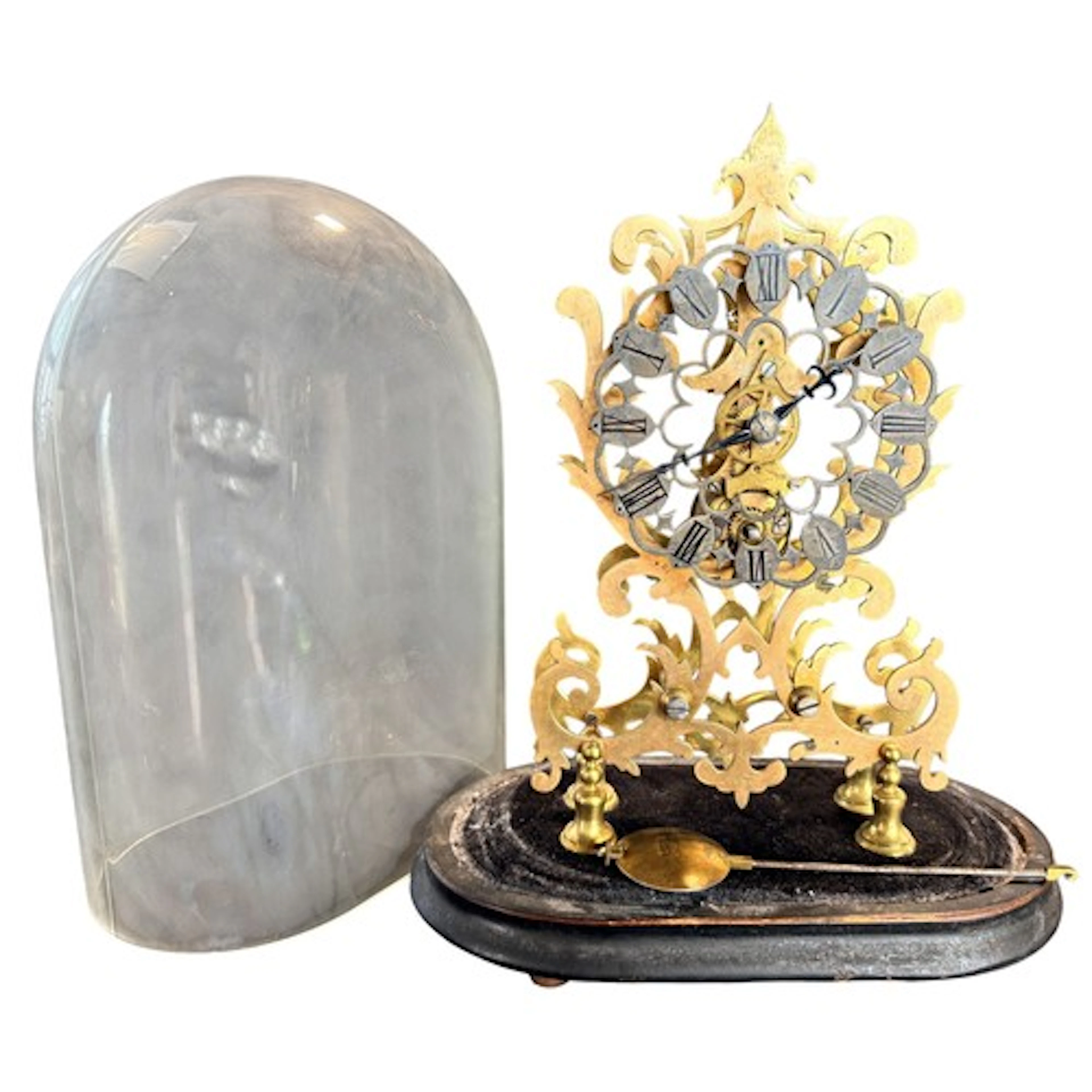 An early 20th century cut brass skeleton clock under glass d...