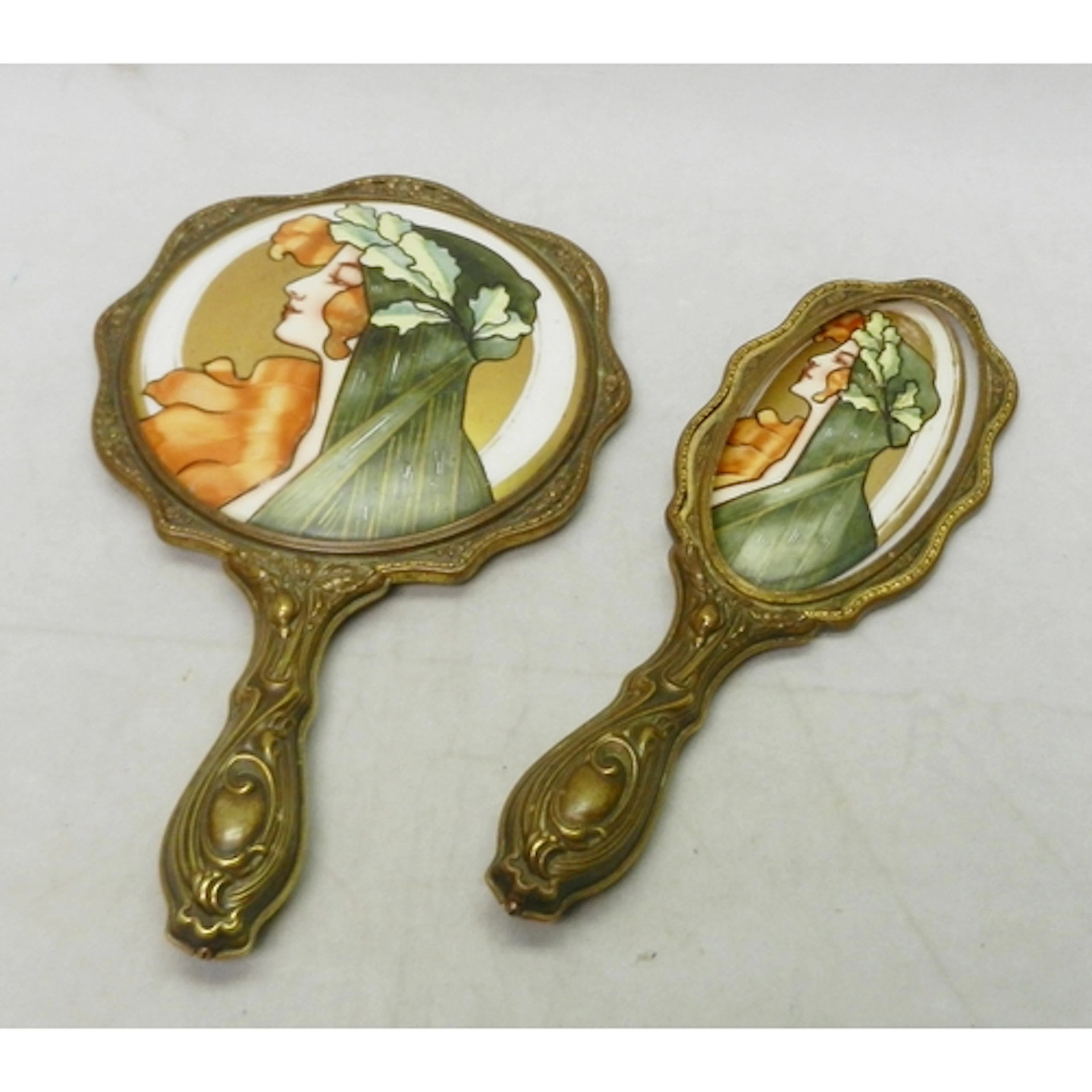 A Jugendstil Art Nouveau hand mirror and part hair brush rep...