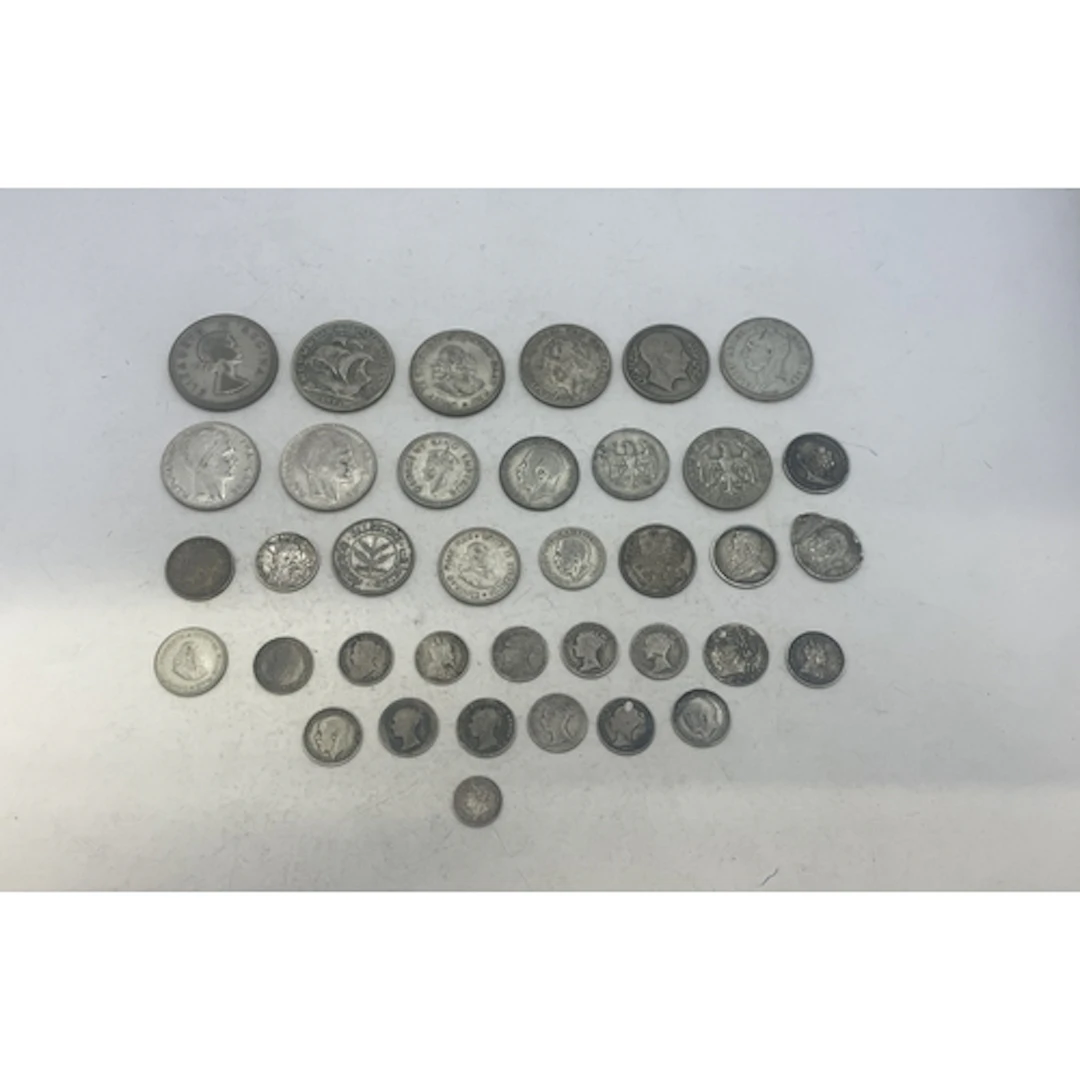 A group of mixed silver coins to include examples from UK (p...