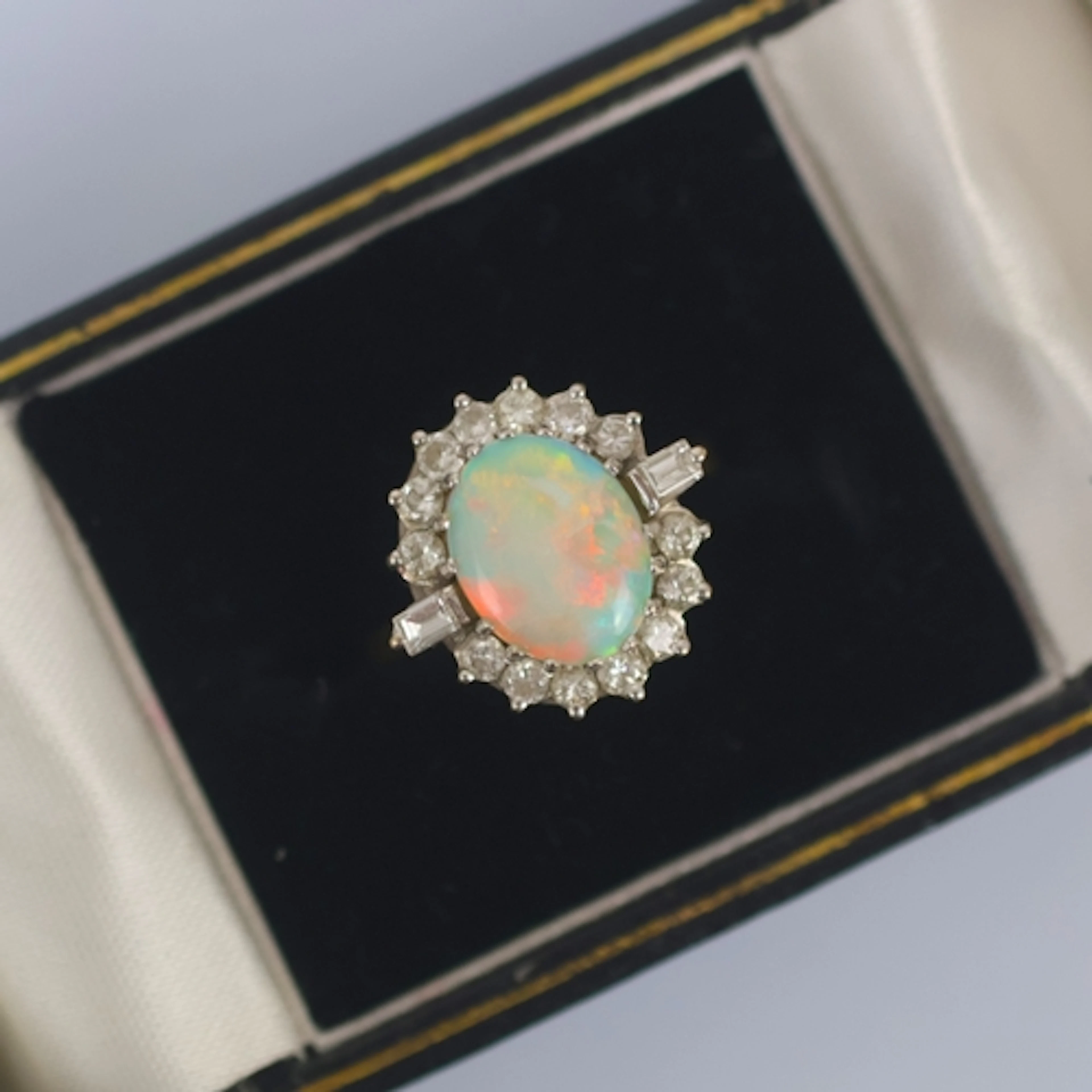A late 20th century opal and diamond ring, the central oval ...