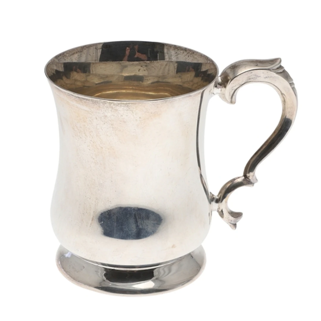 A SILVER MUG, VINER'S LTD. With scroll handle, on a round fo...
