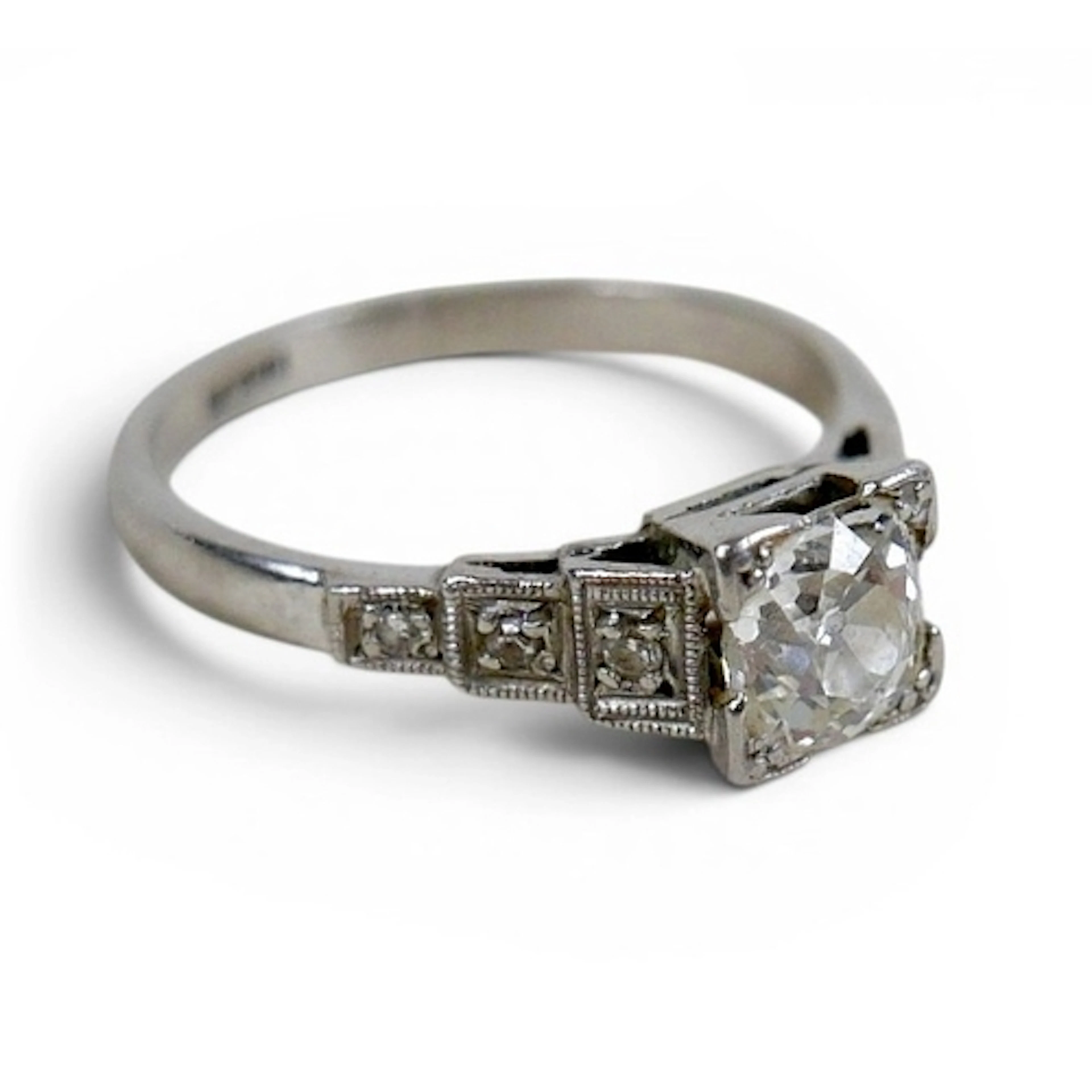 AN ART DECO DIAMOND AND PALLADIUM RING. the central old Euro...