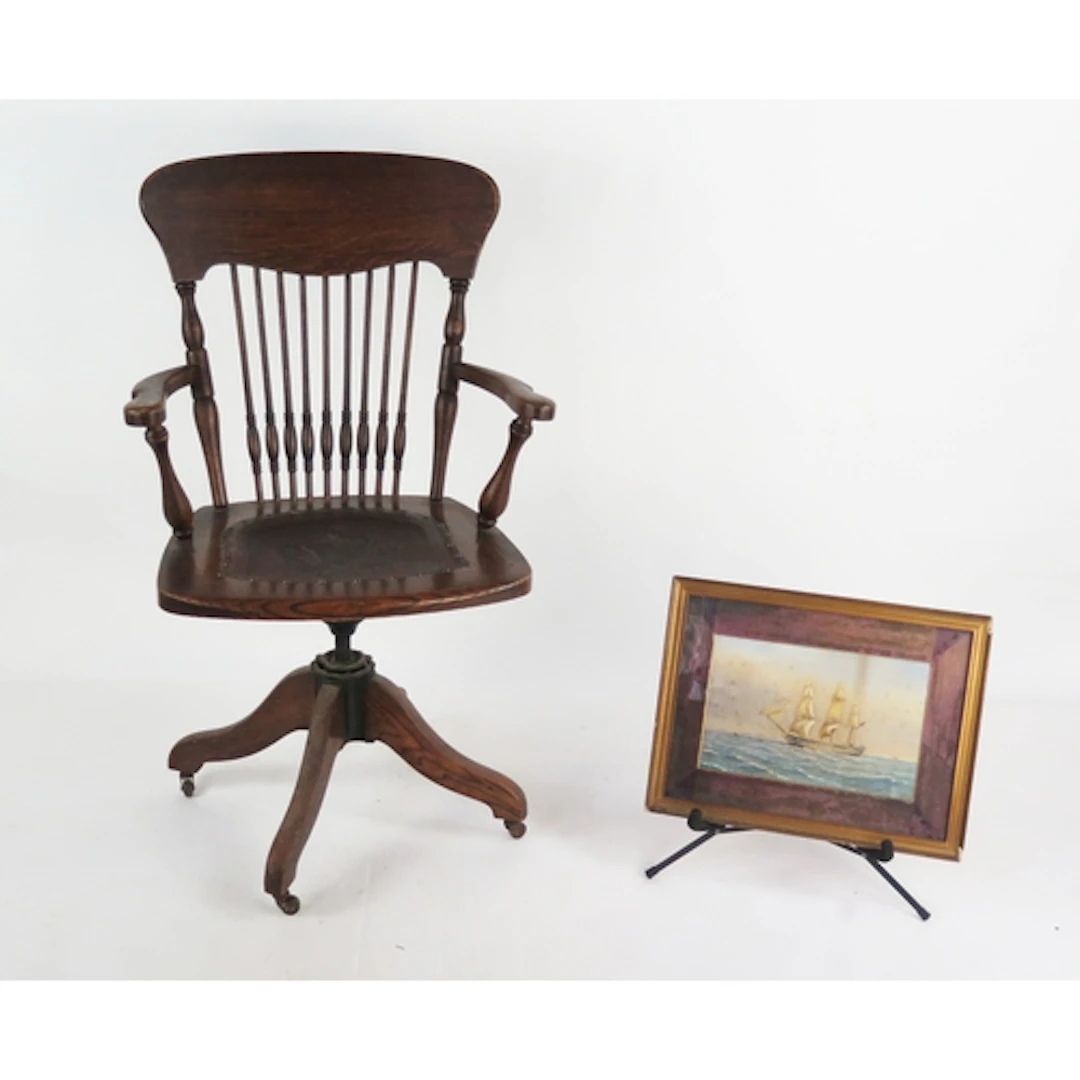 A 19th century elm captain's chair, with shaped top rail and...