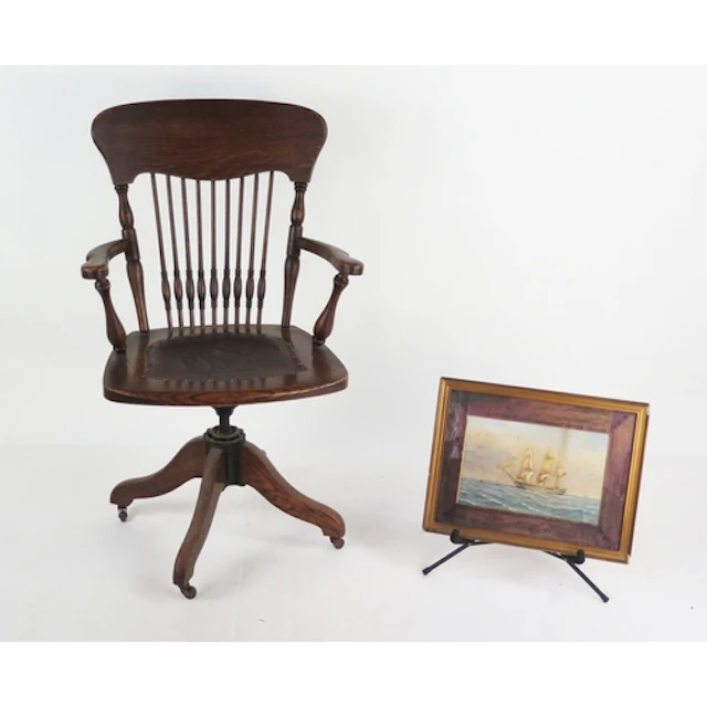 A 19th century elm captain's chair, with shaped top rail and...
