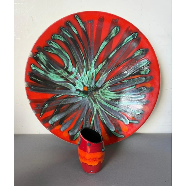 A Poole Pattern Charger in Delphis pattern with a small vase...