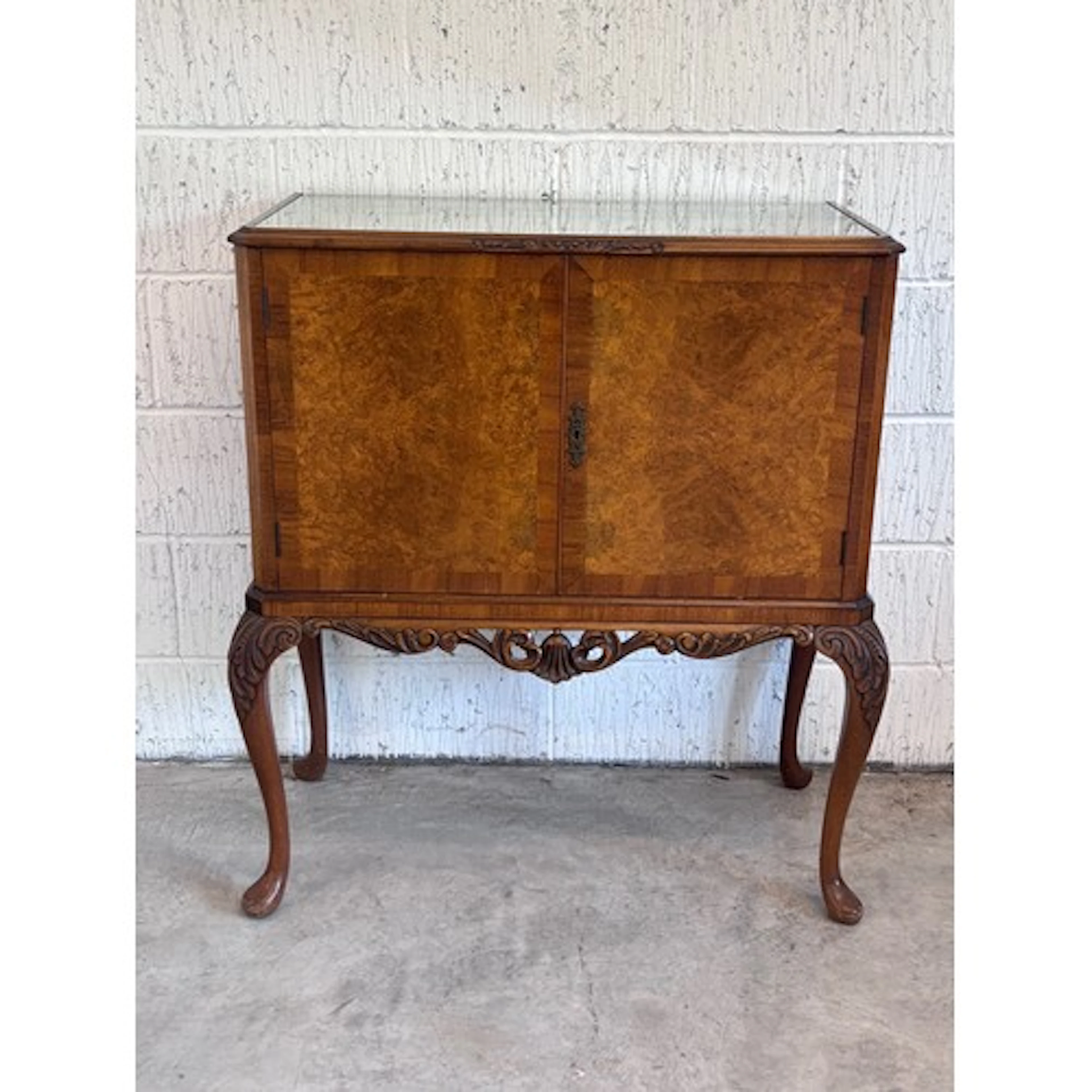 A Queen Anne style walnut cocktail cabinet, the rectangular ...