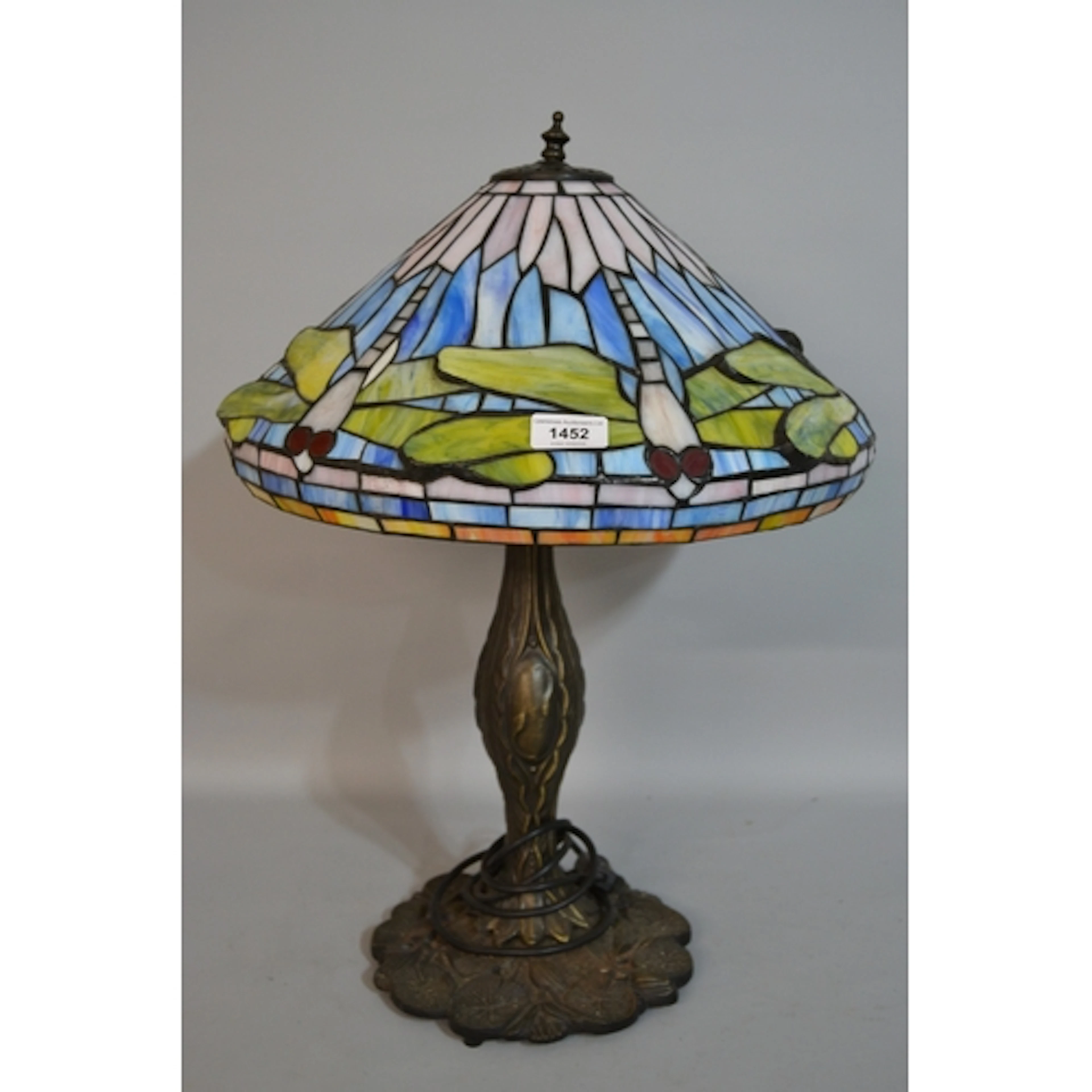 Tiffany style patinated metal and leaded glass table lamp