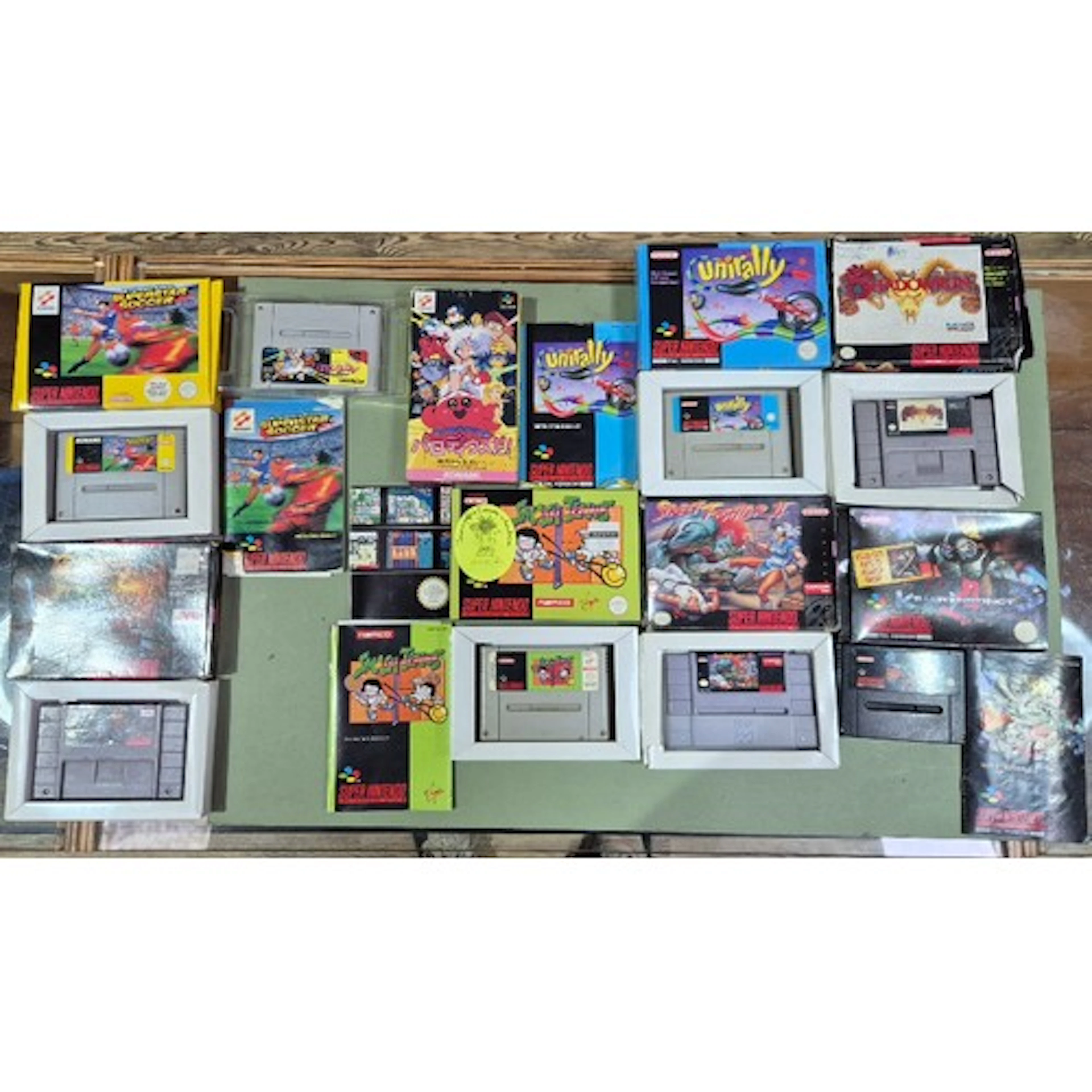 A box of assorted SNES games to include Dungeon Master, Inte...