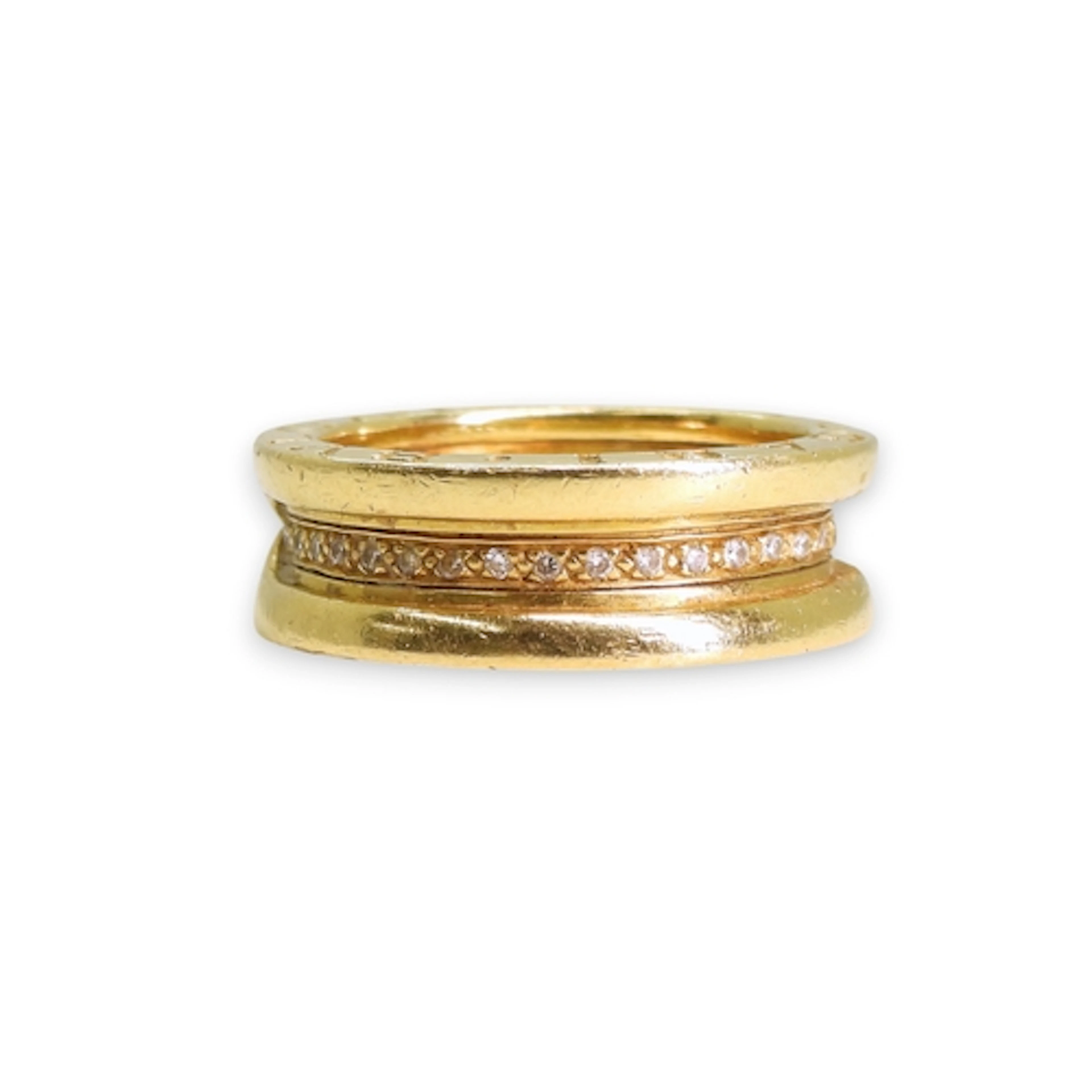A yellow metal Bvlgari style ring, set with diamonds, finger...