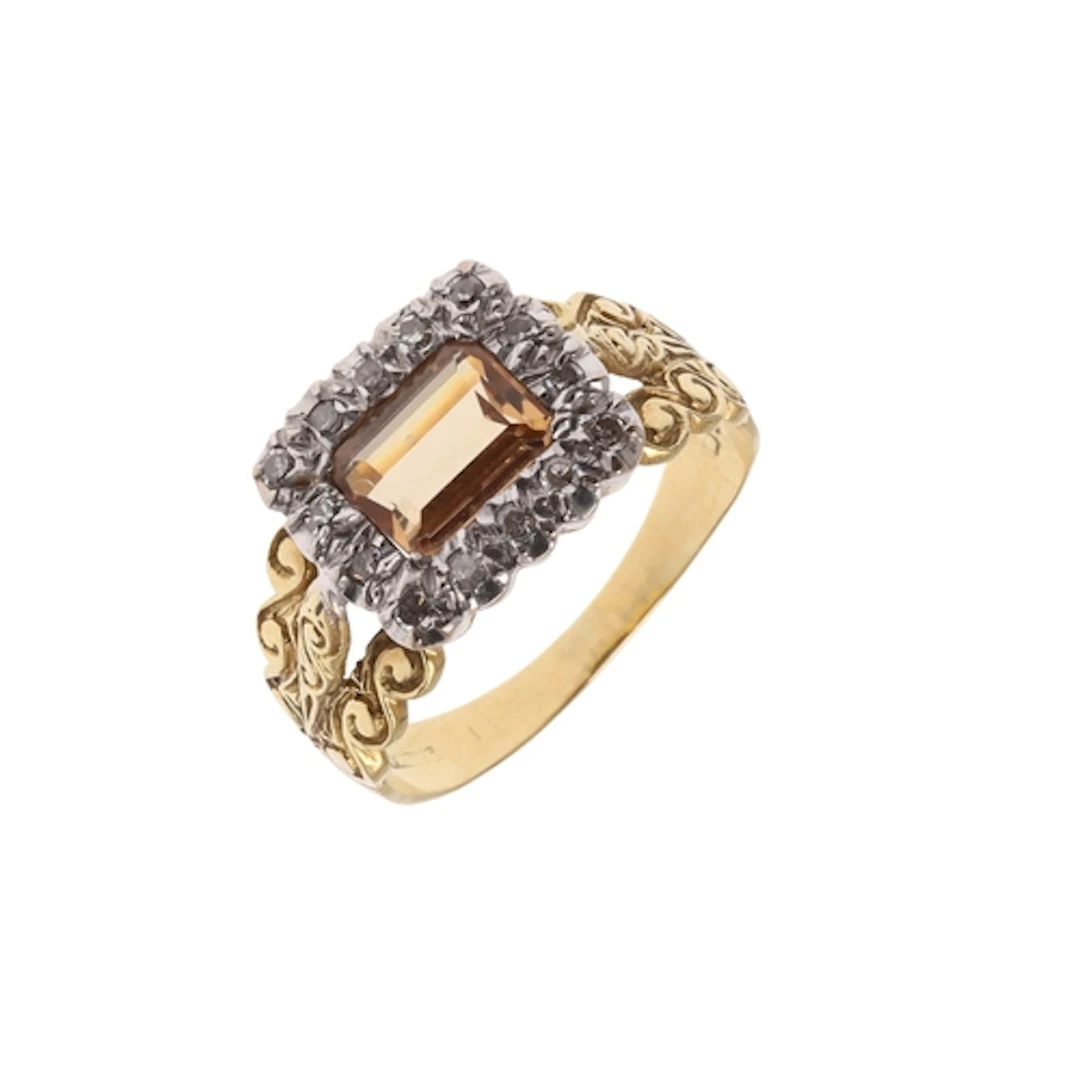 A CITRINE AND DIAMOND RING. the step-cut citrine is set with...