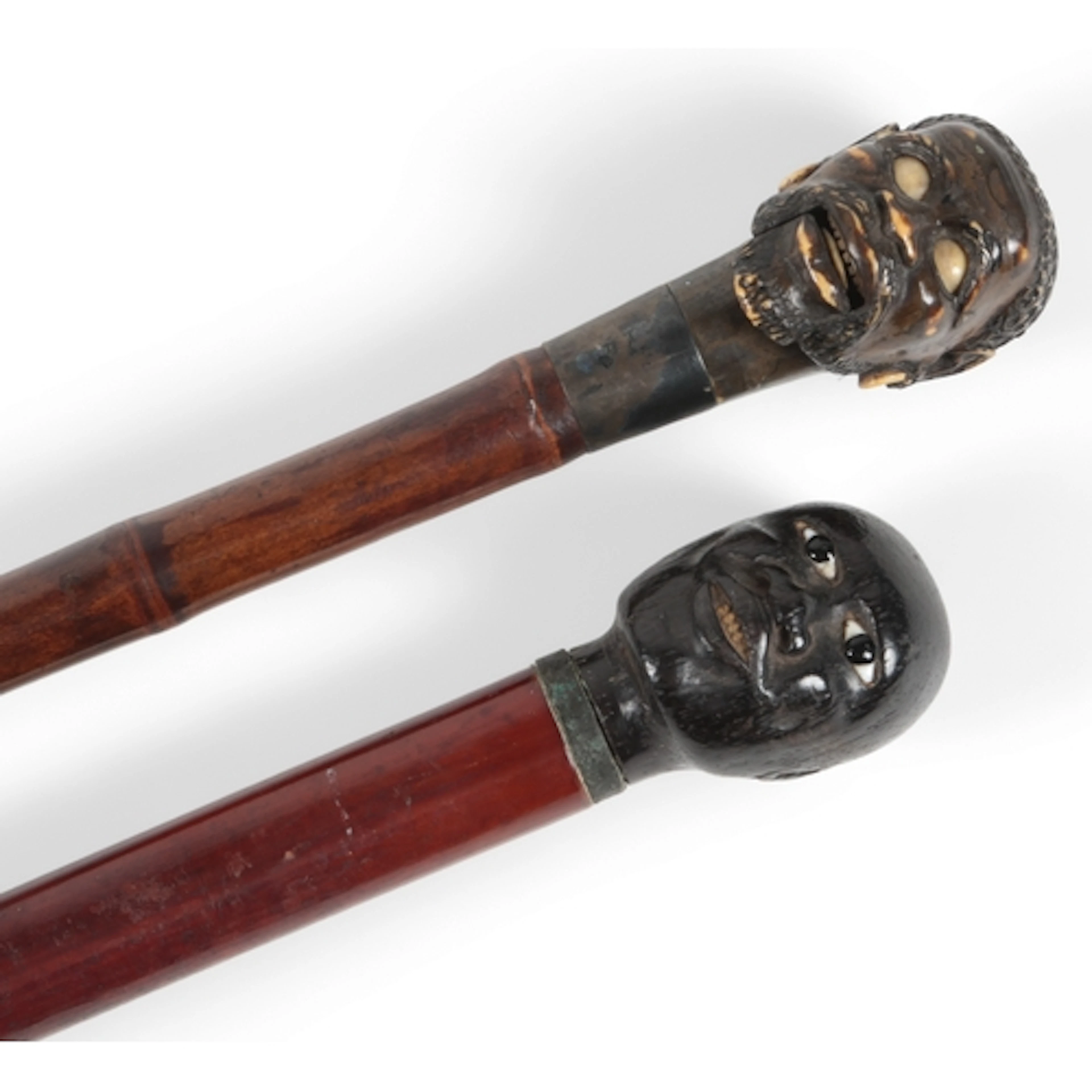 Two Blackamoor head walking canes, the first with carved and...