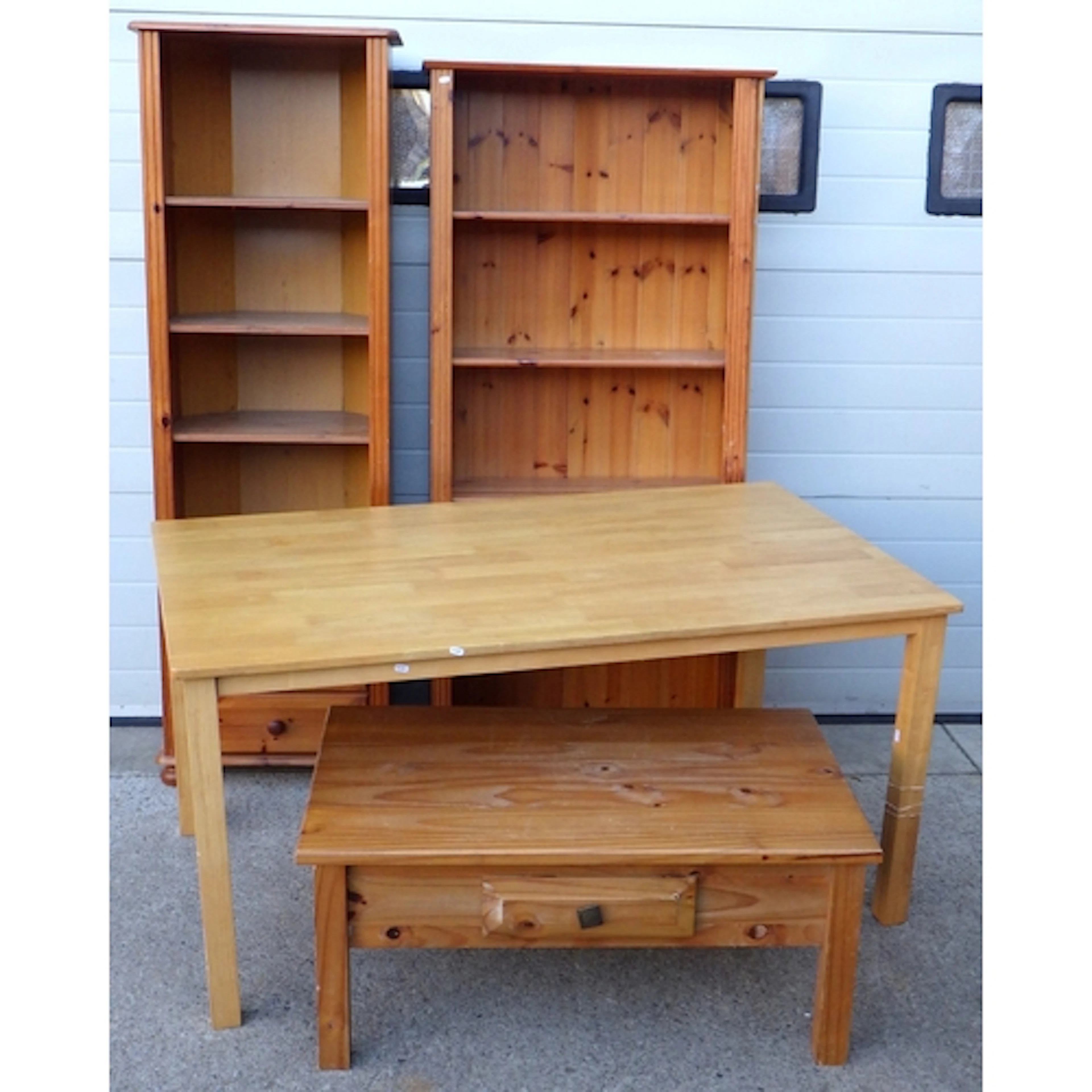 A kitchen table, pine coffee table, bookshelves and corner s...