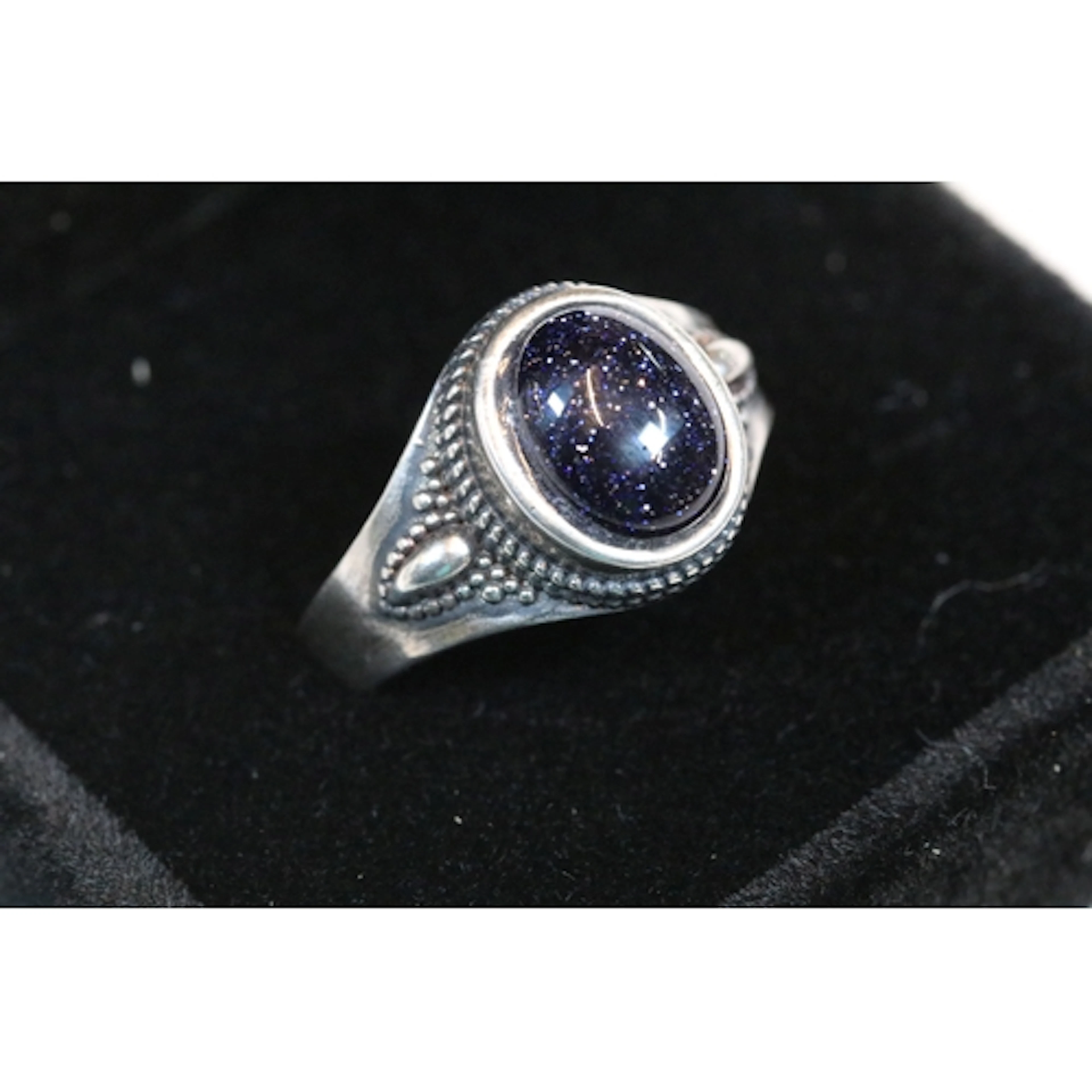 A ladies silver ring set with oval Blue Sandstone cabochon c...