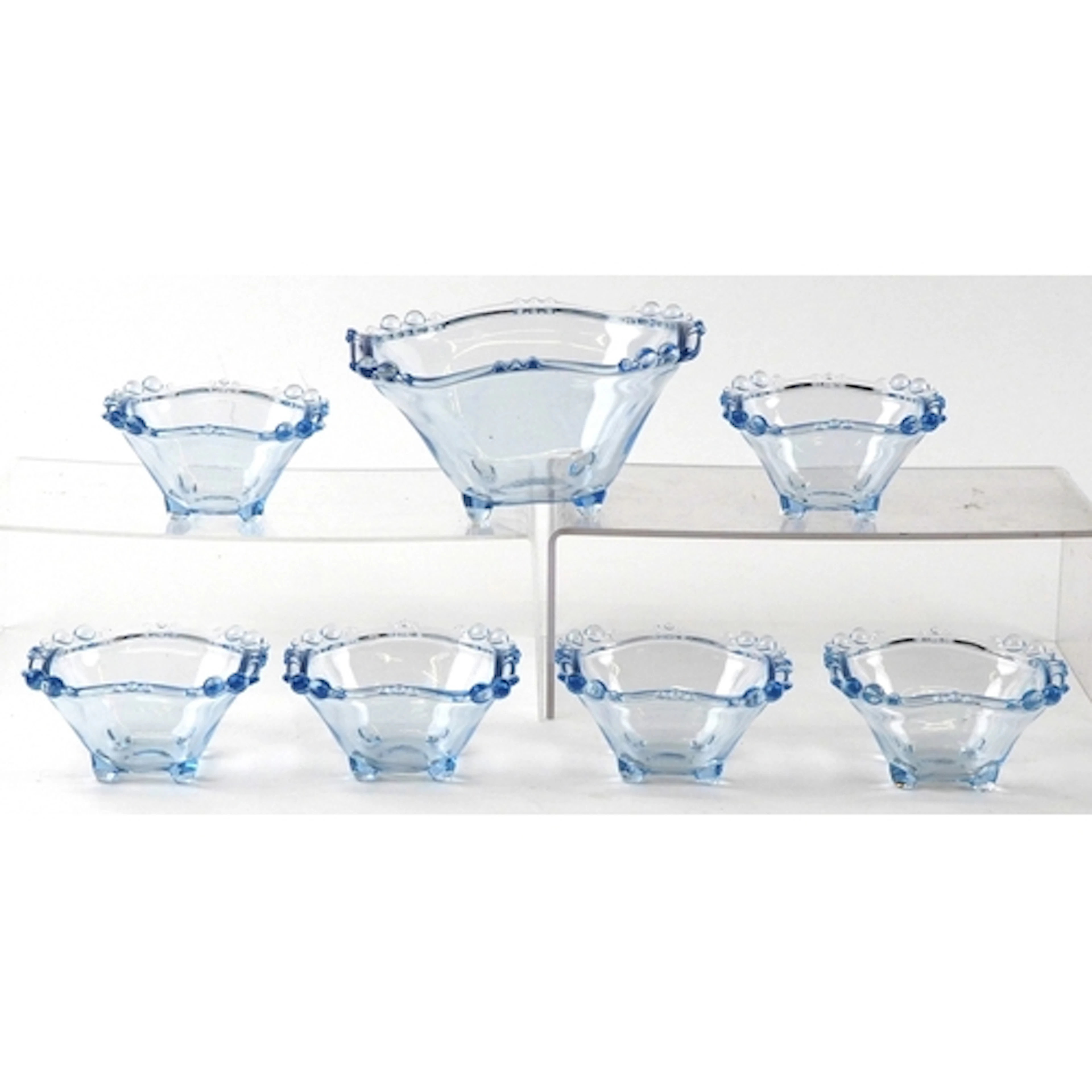 Set of seven Art Deco style blue pressed glass bowls with la...