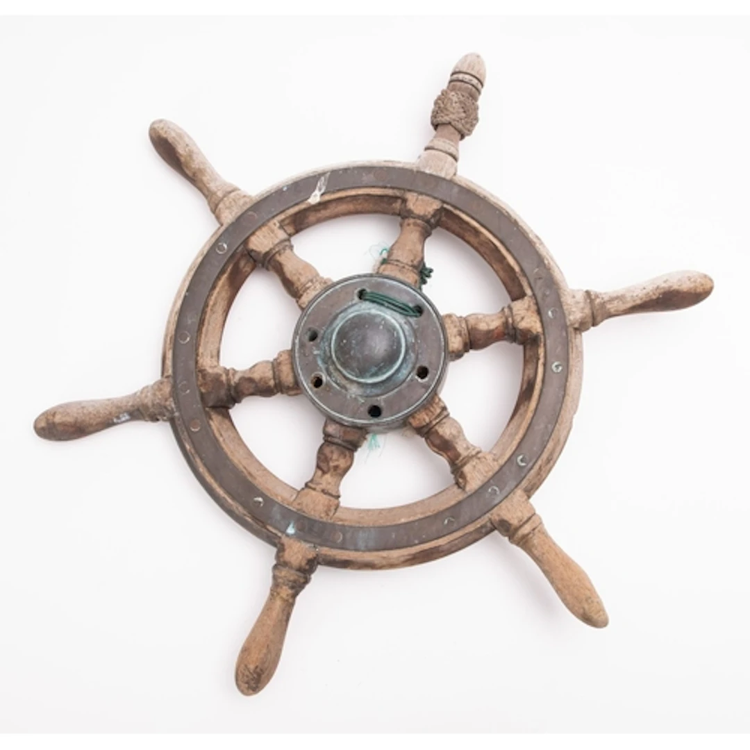 A wood and bronze ships helm of small size. Having a bronze ...