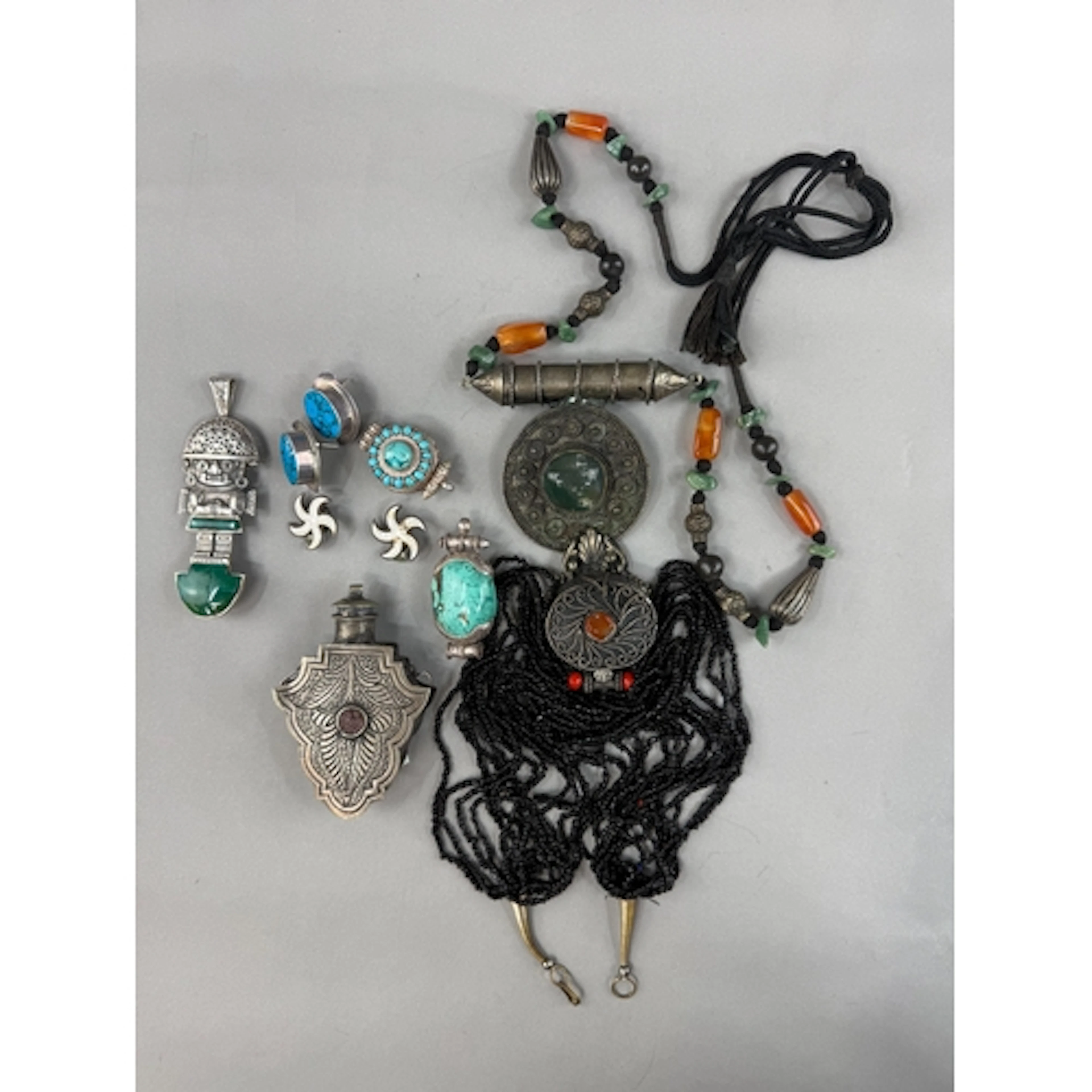 Jewellery: a South American white metal malachite set figura...