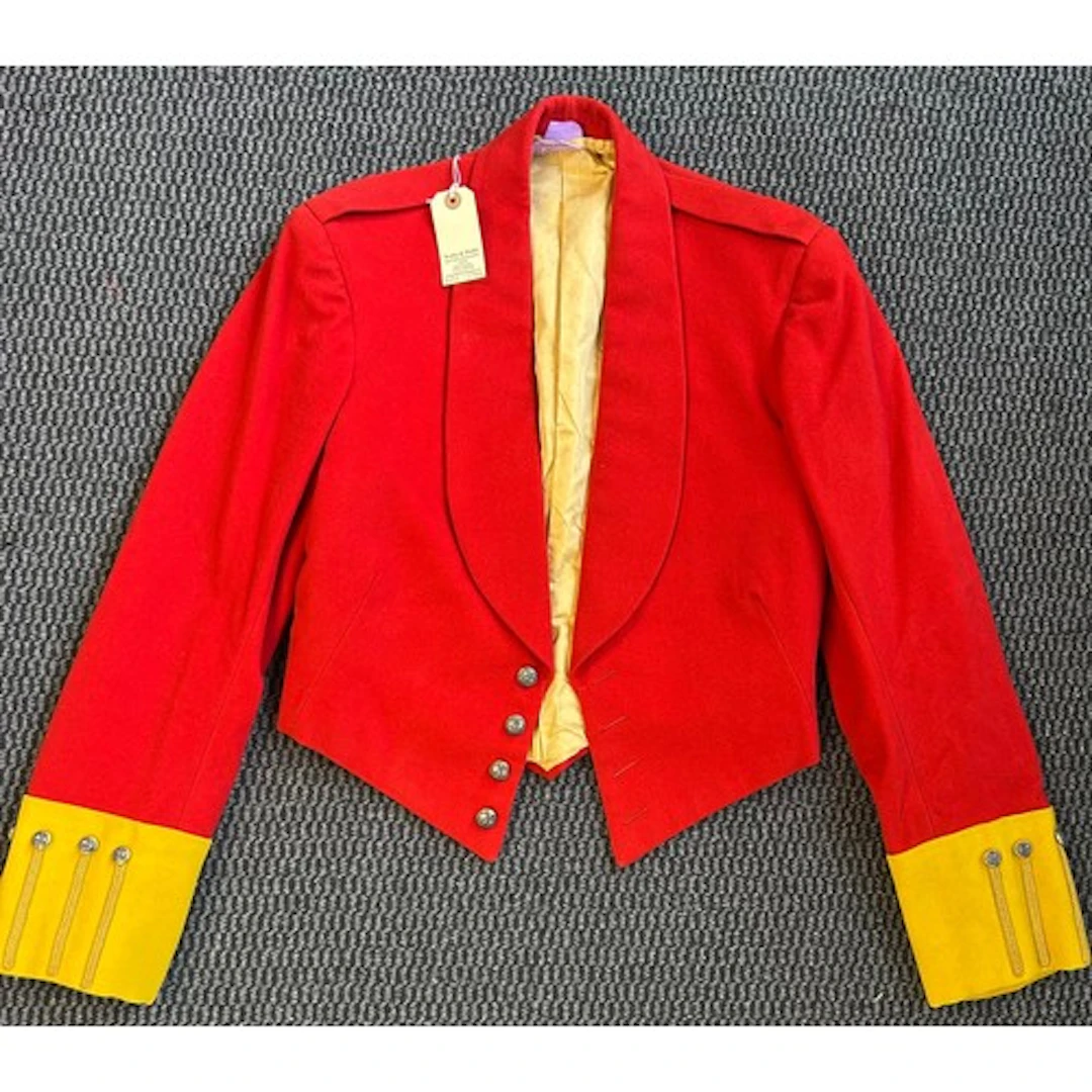 An Officer's scarlet mess tunic with yellow facings of the M...