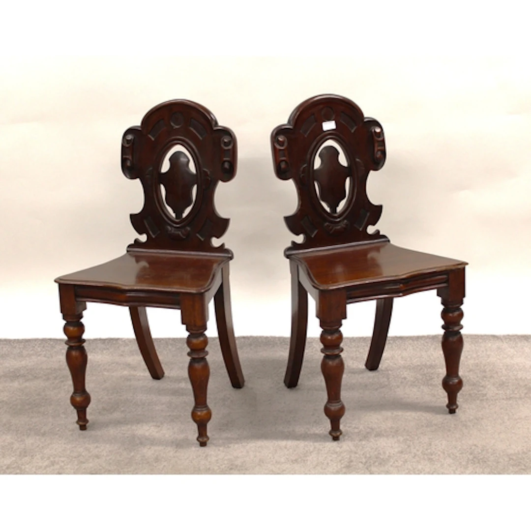 Pair of Victorian mahogany hall chairs with pierced carved b...