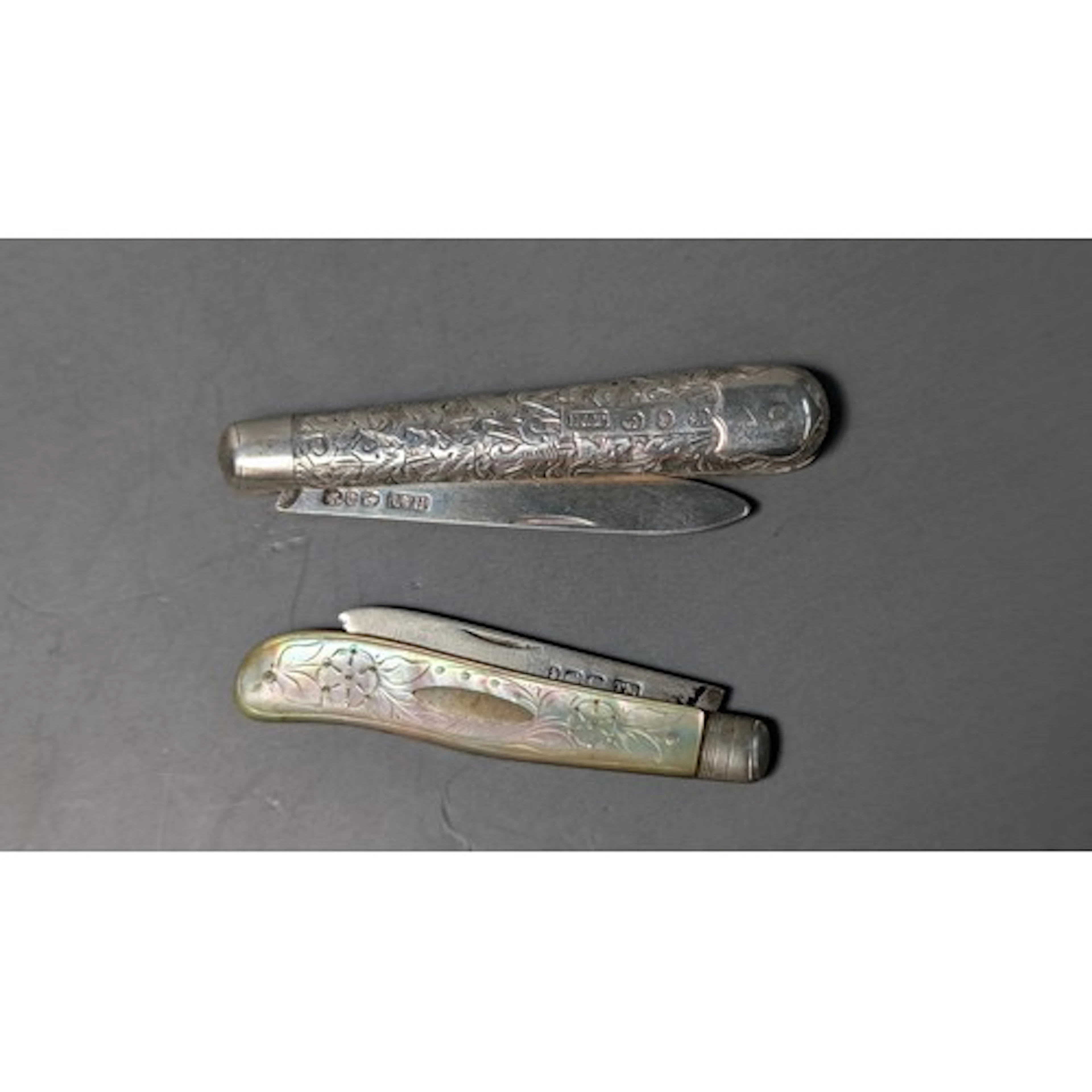 Two late Victorian silver fruit knives, comprising: one with...