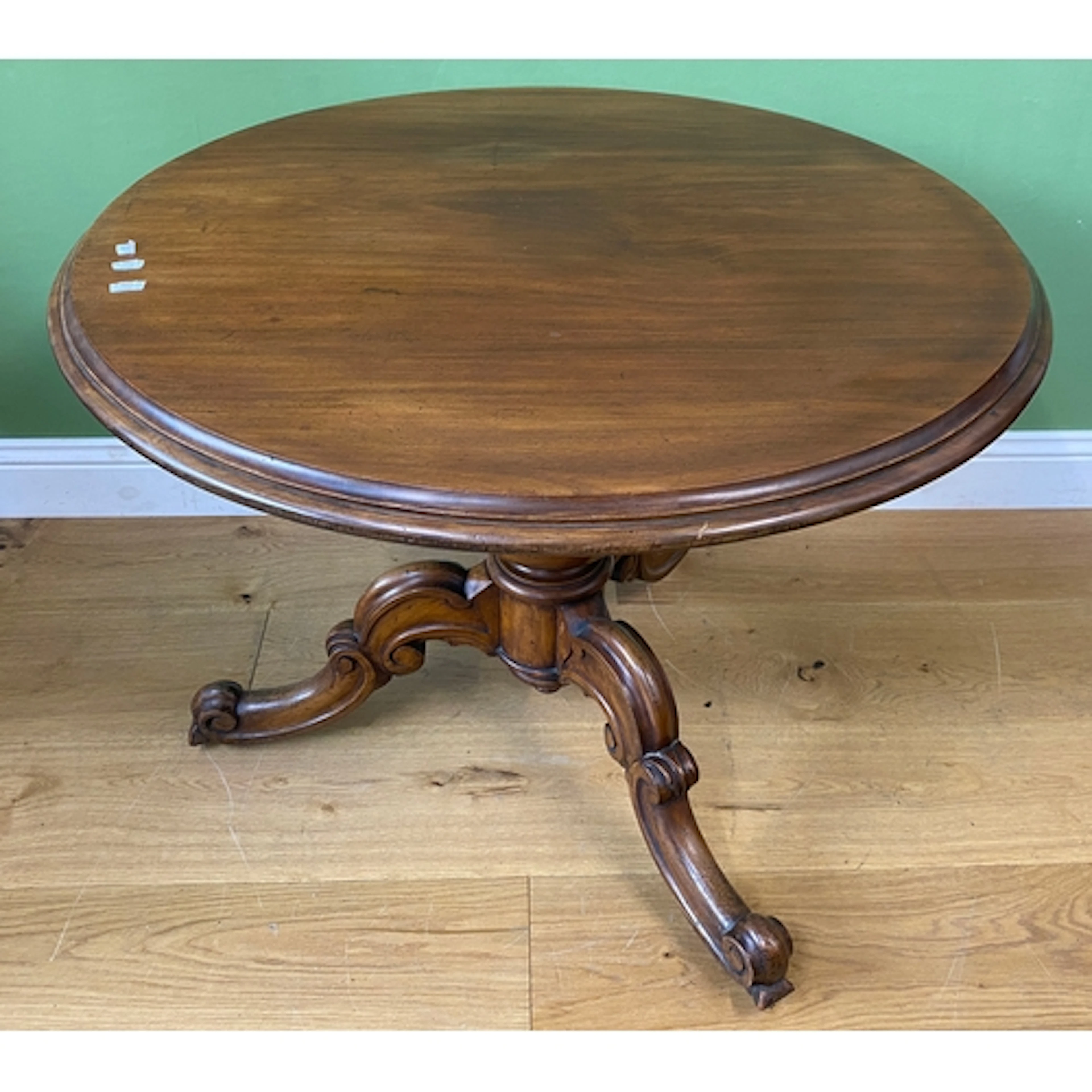 A 19th century mahogany circular tilt-top centre table on a ...